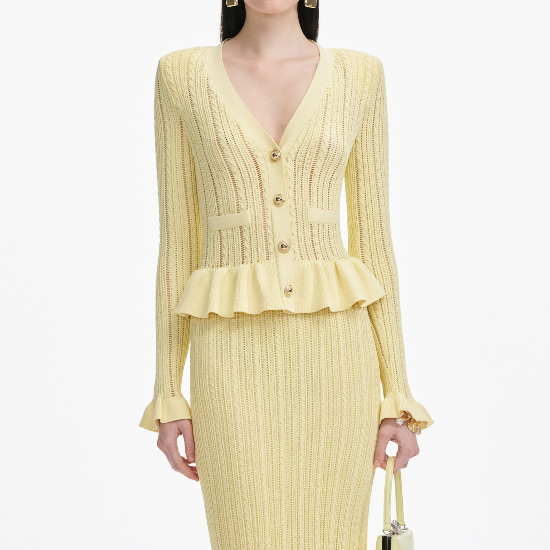 A close up of a woman wearing the Yellow Knit Peplum Midi Dress