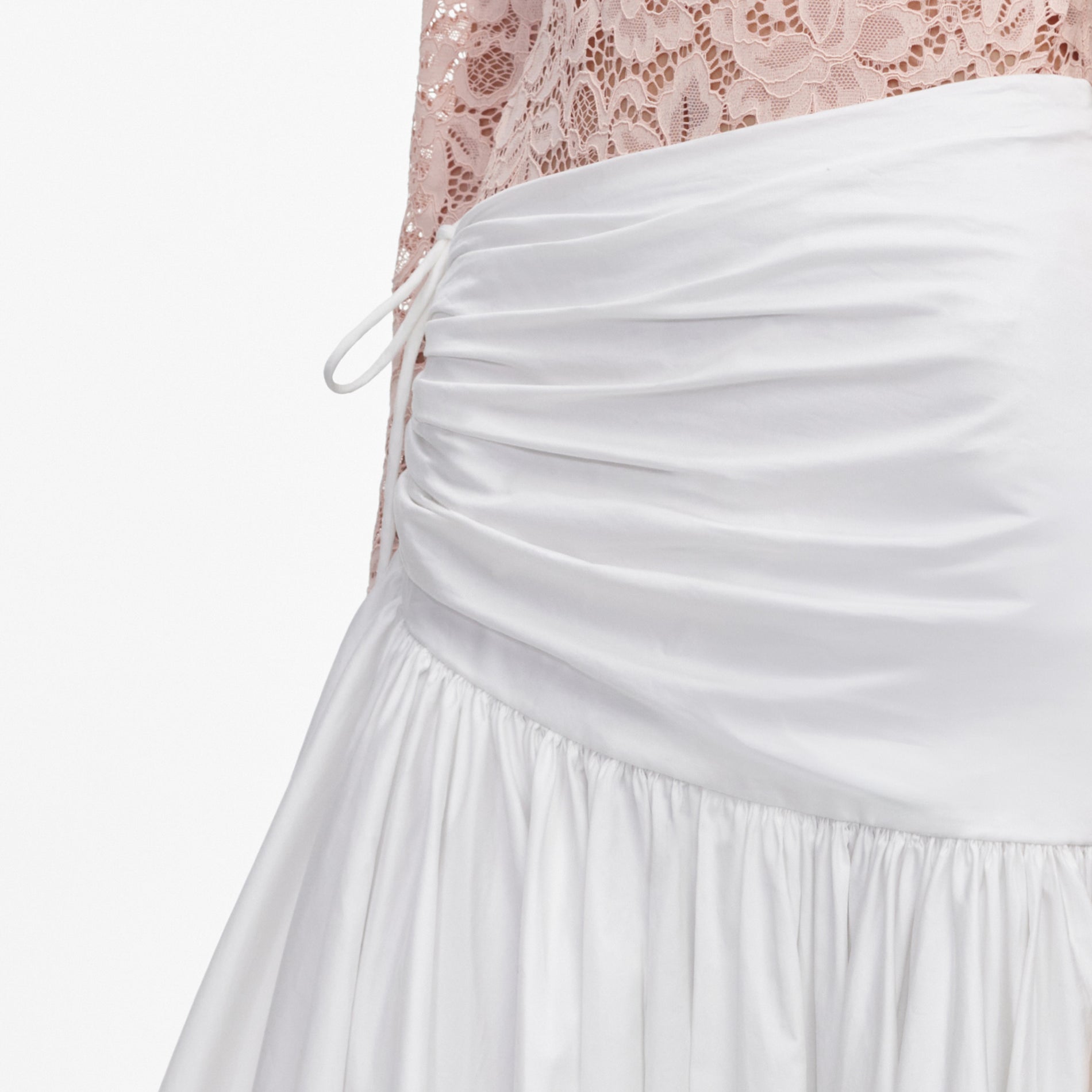 A close up of a woman wearing the White Cotton Asymmetric Midi Skirt