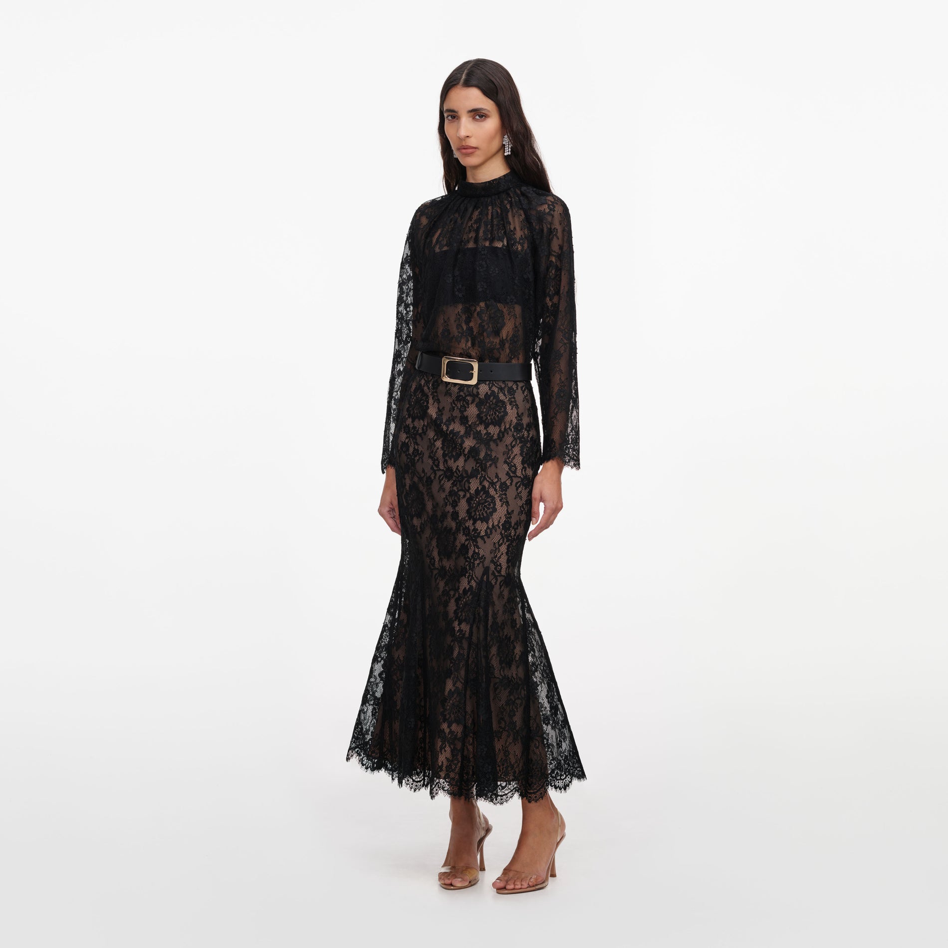 Side view of a woman wearing the Black Lace Midi Skirt