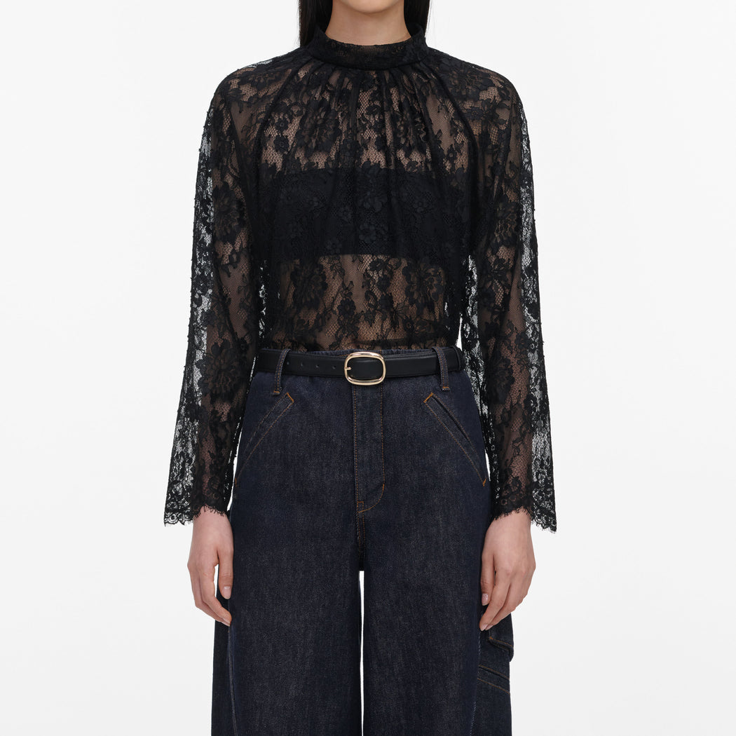 A close up of a woman wearing the Black Lace Blouse