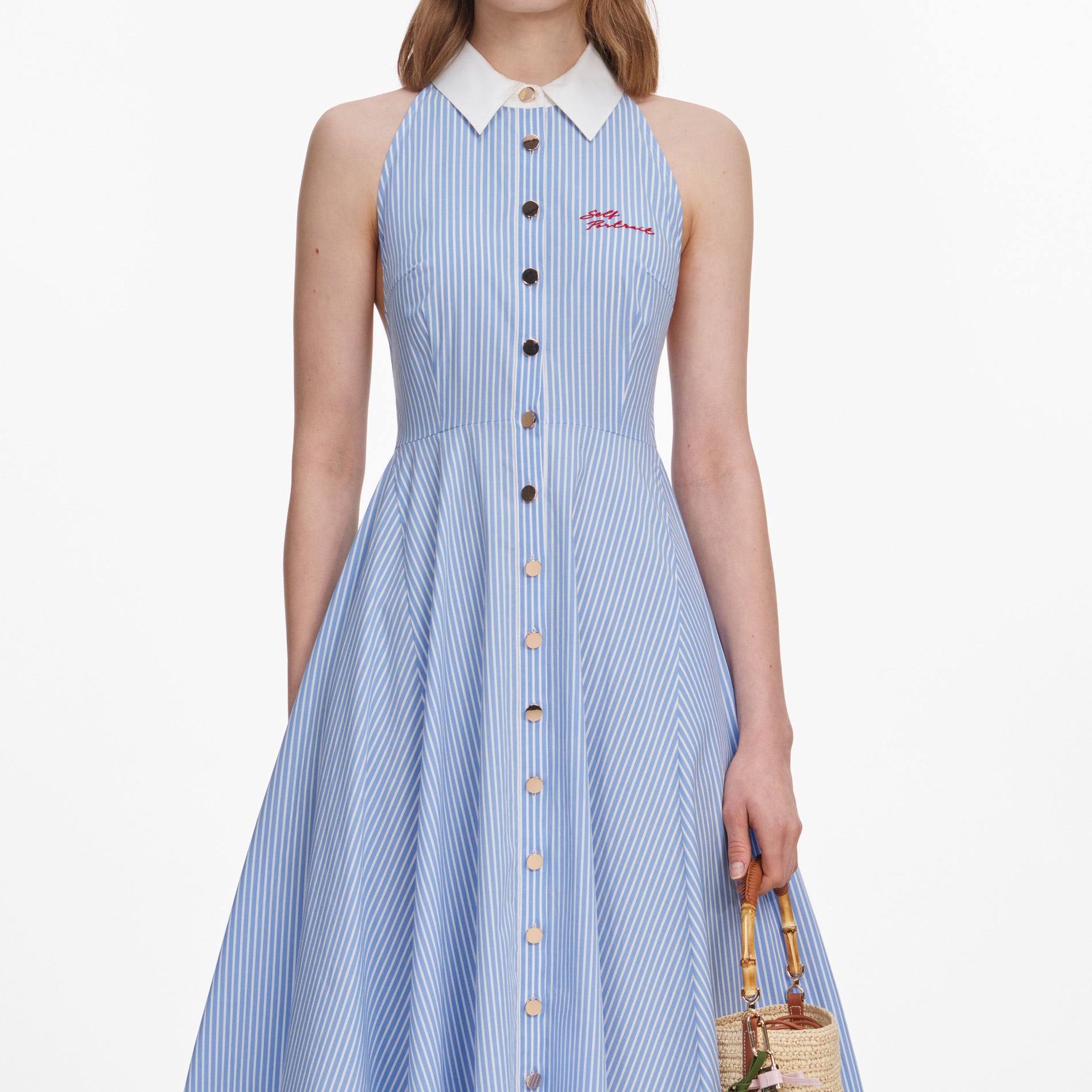 A close up of a woman wearing the Blue Striped Cotton Midi Dress