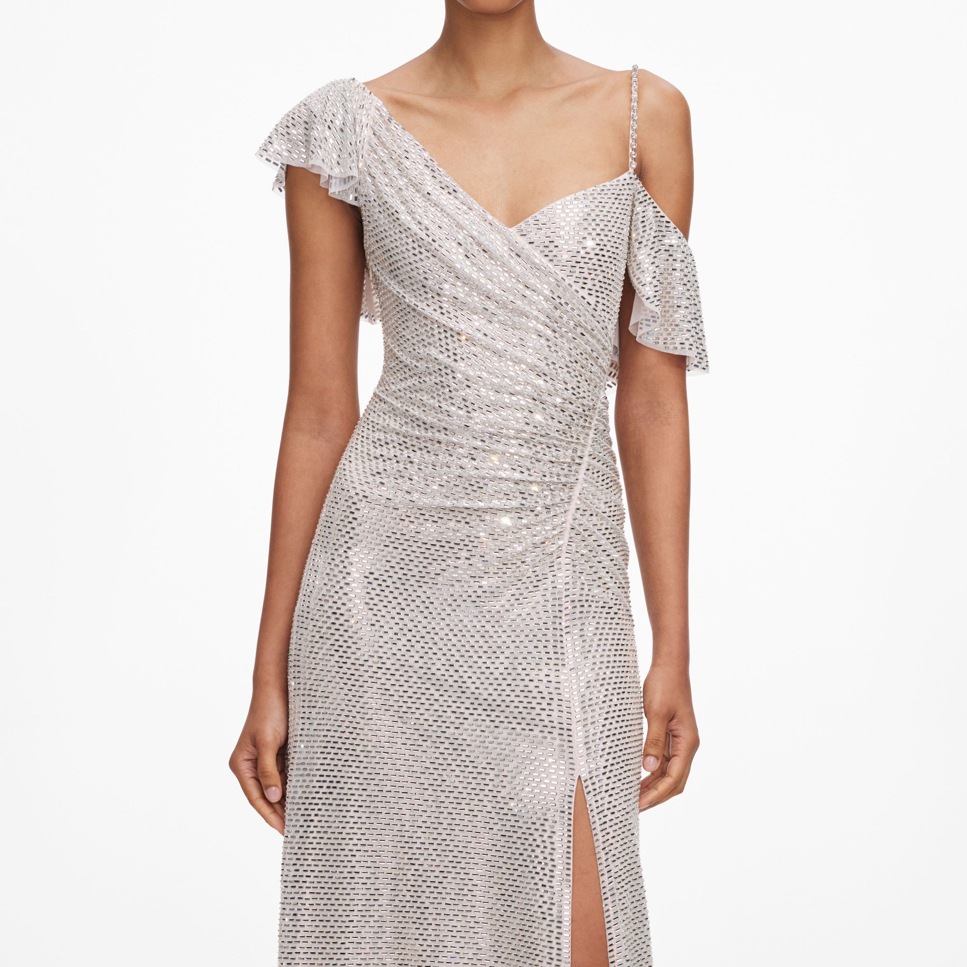 A close up of a woman wearing the Champagne Rhinestone Ruffle Draped Maxi Dress