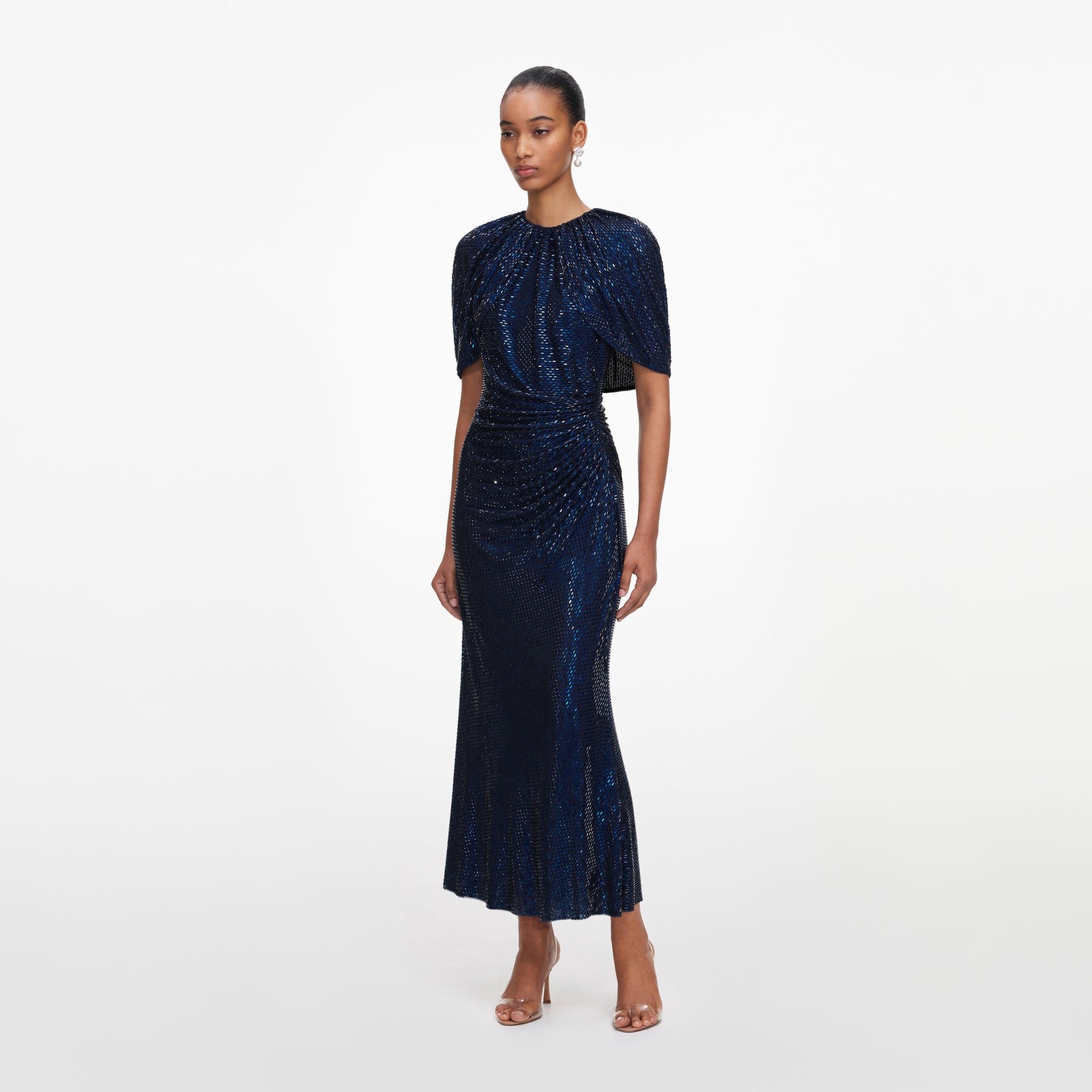 Side view of a woman wearing the Navy Rhinestone Cape Sleeve Midi Dress