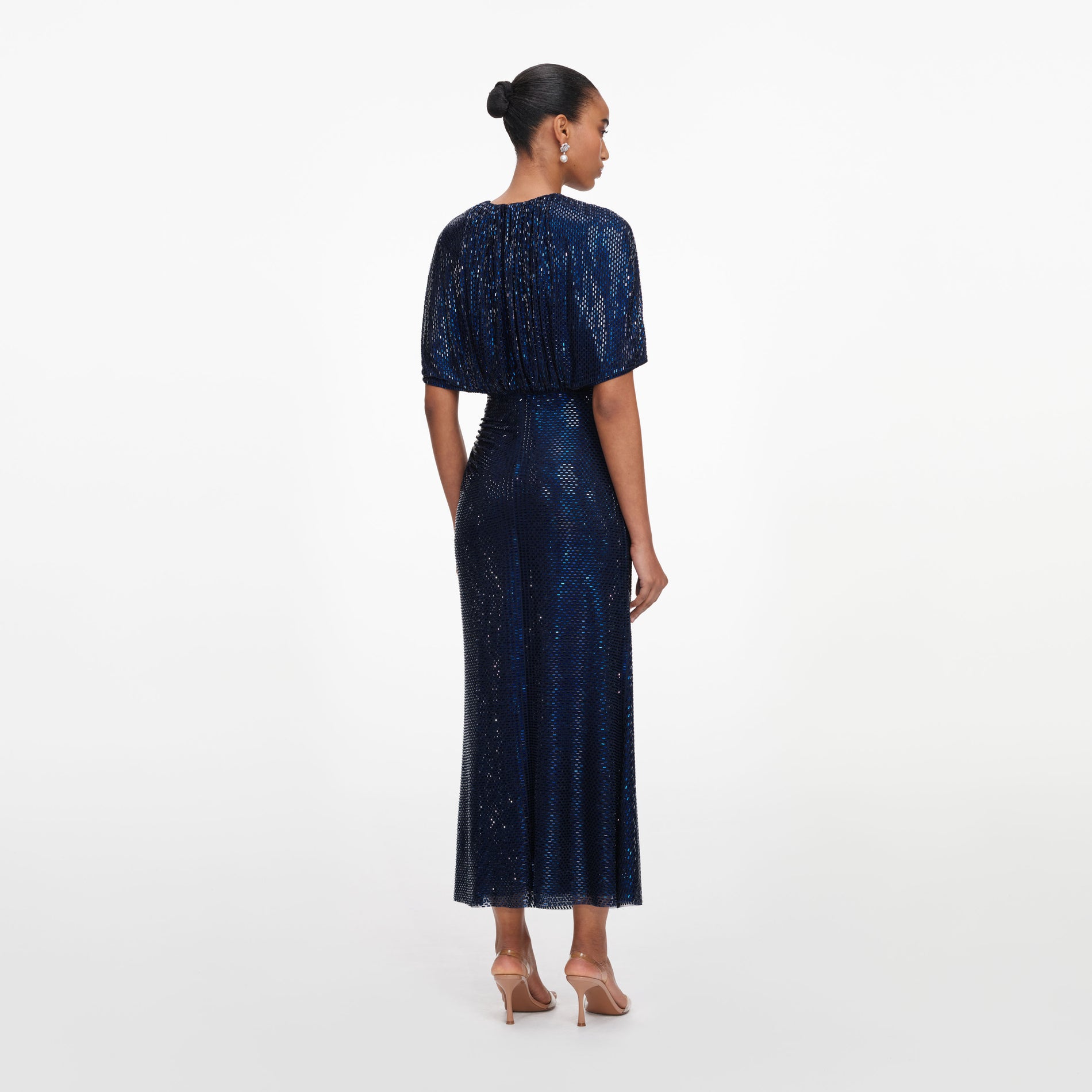 Back view of a woman wearing the Navy Rhinestone Cape Sleeve Midi Dress