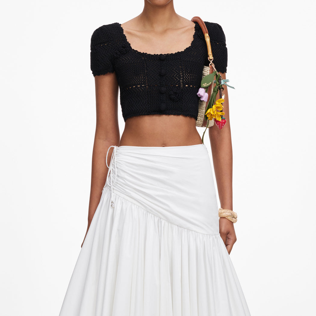 A close up of a woman wearing the Black Crochet Knit Crop Top