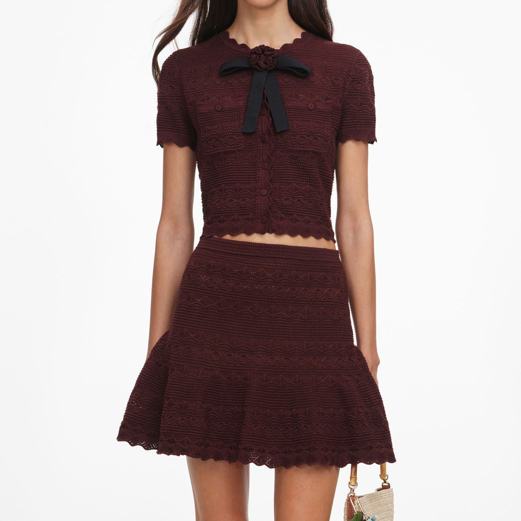 A close up of a woman wearing the Brown Pointelle Knit Mini Skirt