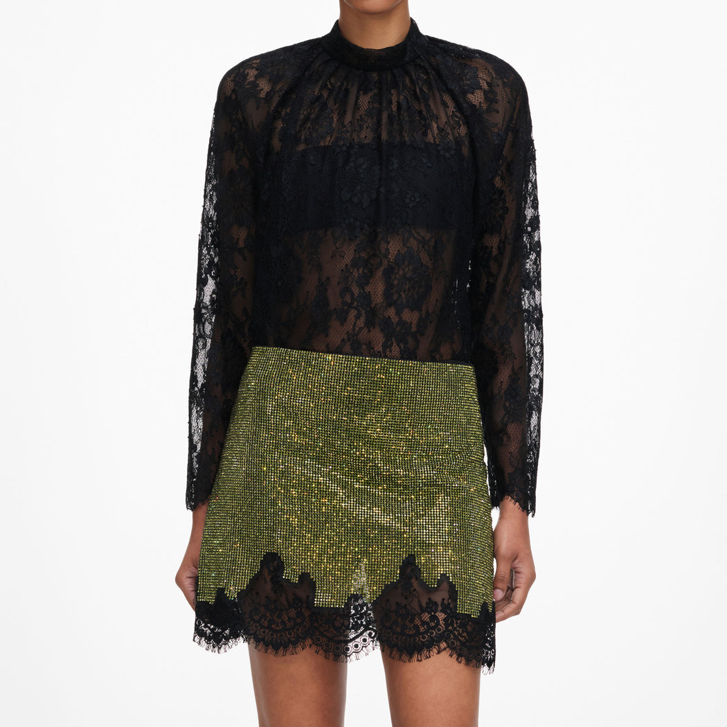 A close up of a woman wearing the Green Crystal Chainmail Mini Skirt