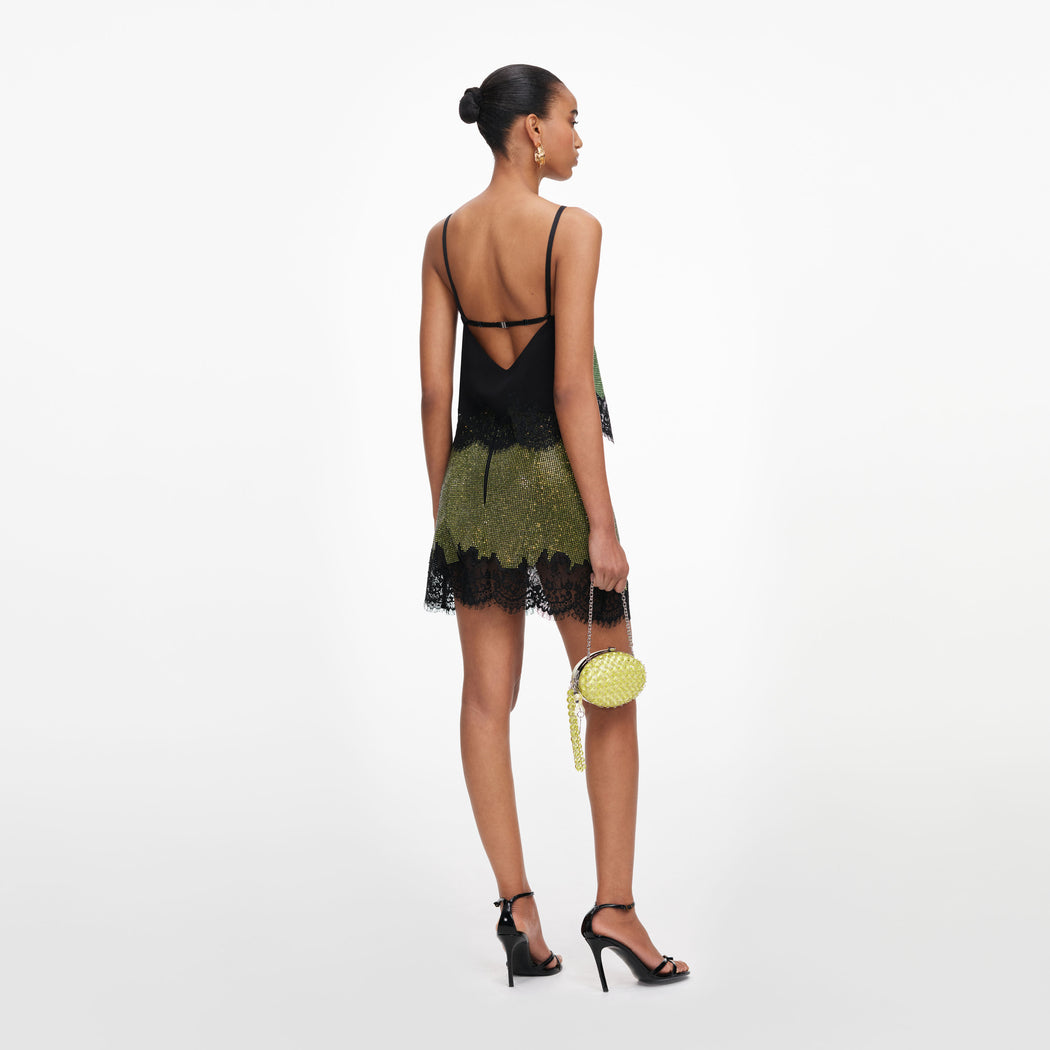Back view of a woman wearing the Green Crystal Chainmail Top