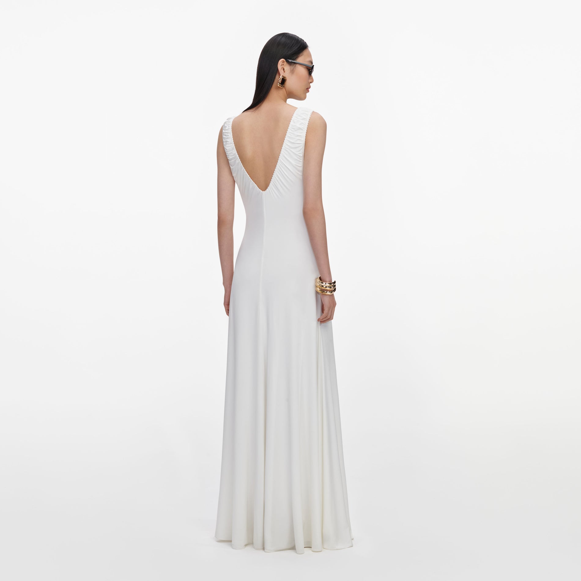 Back view of a woman wearing the White Jersey Ruched Maxi Dress