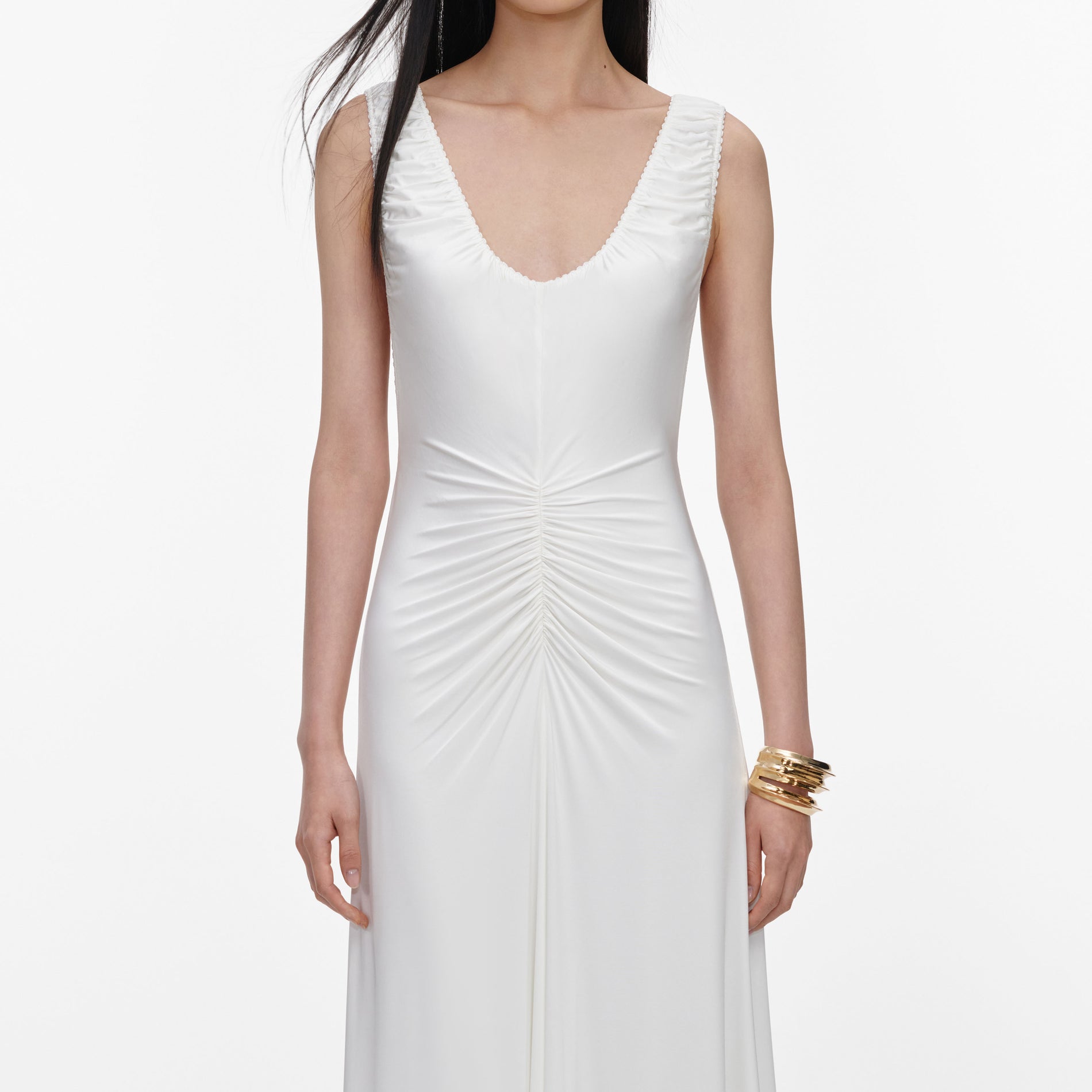 A close up of a woman wearing the White Jersey Ruched Maxi Dress