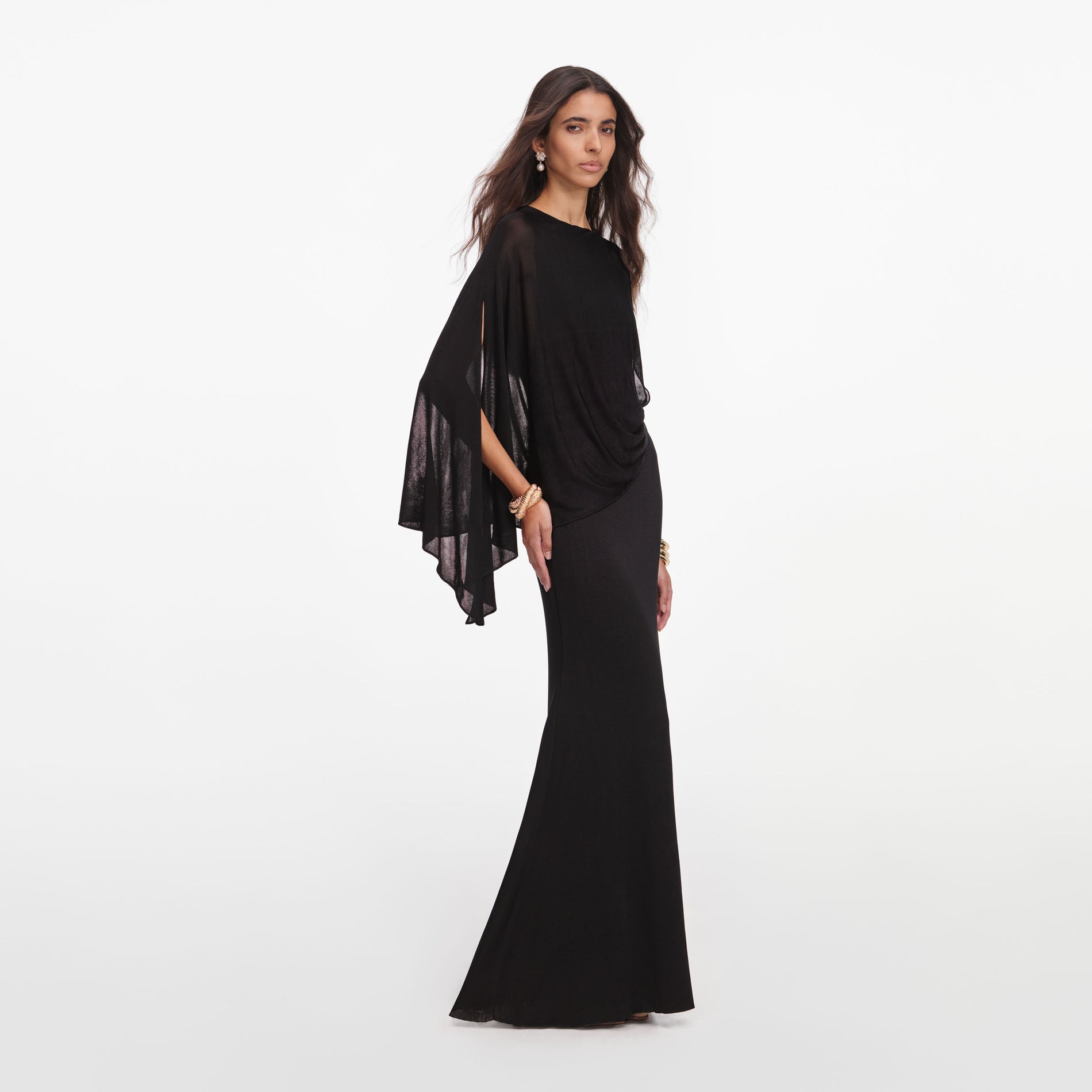 Side view of a woman wearing the Black Viscose Knit One Shoulder Maxi Dress