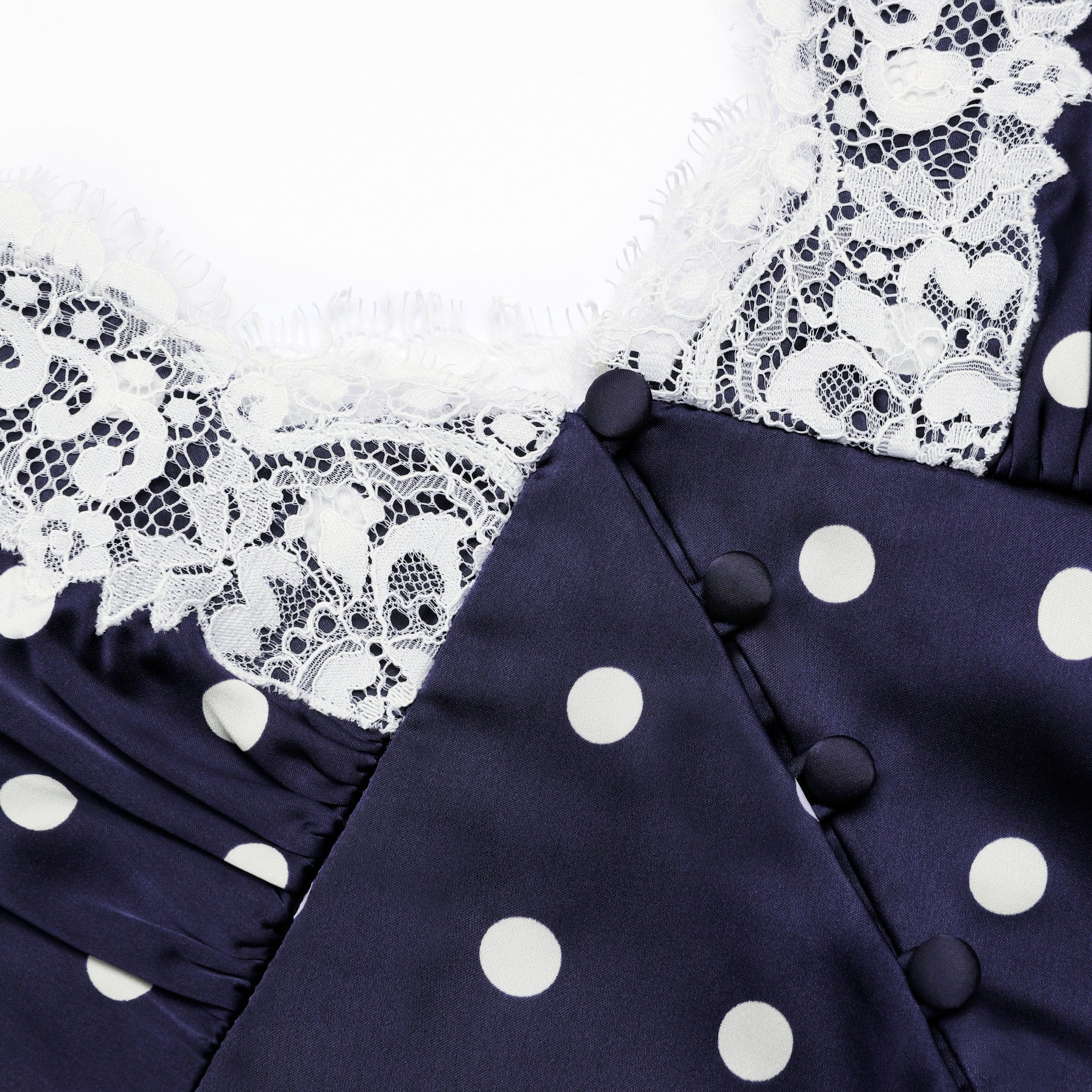 A close up of the fabric for the Navy Polka Dot Satin Mini Dress