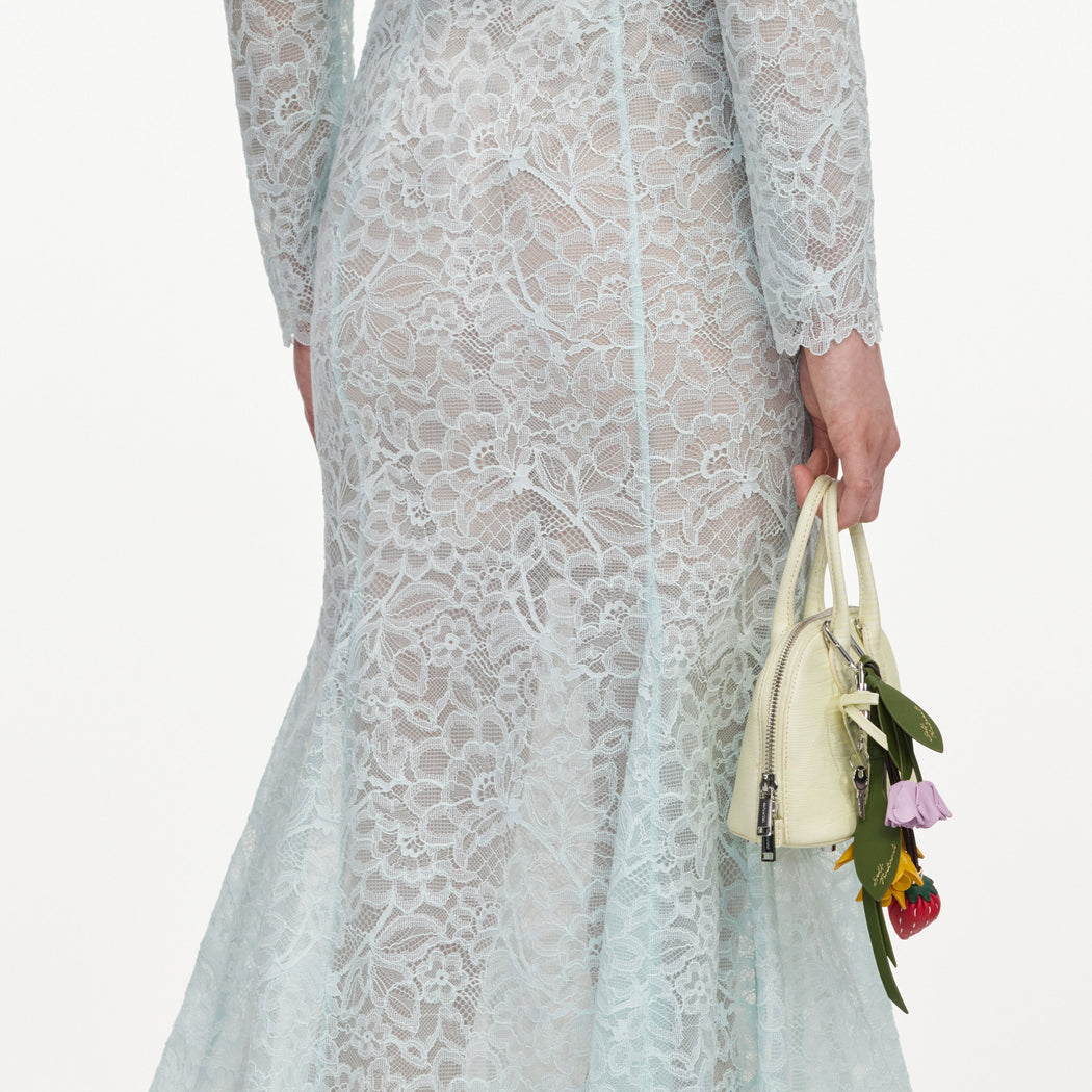 A close up of a woman wearing the Mint Lace Midi Skirt