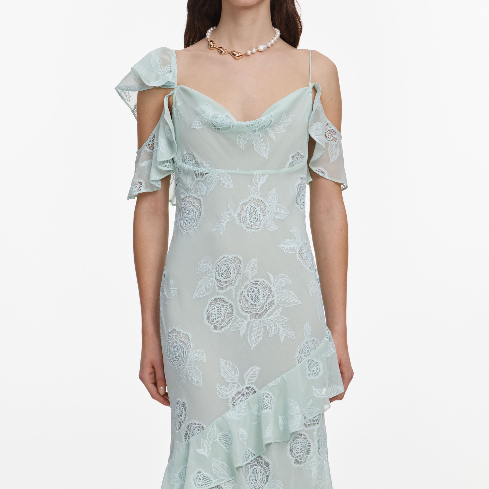 A close up of a woman wearing the Mint Embroidered Georgette Maxi Dress