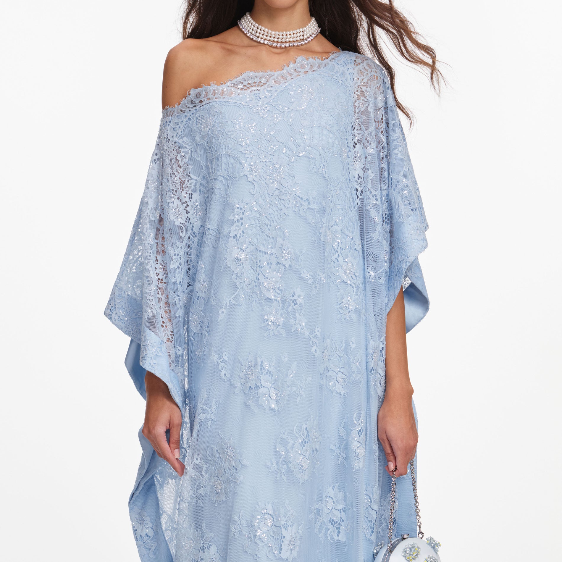 A close up of a woman wearing the Blue Embellished Lace Kaftan