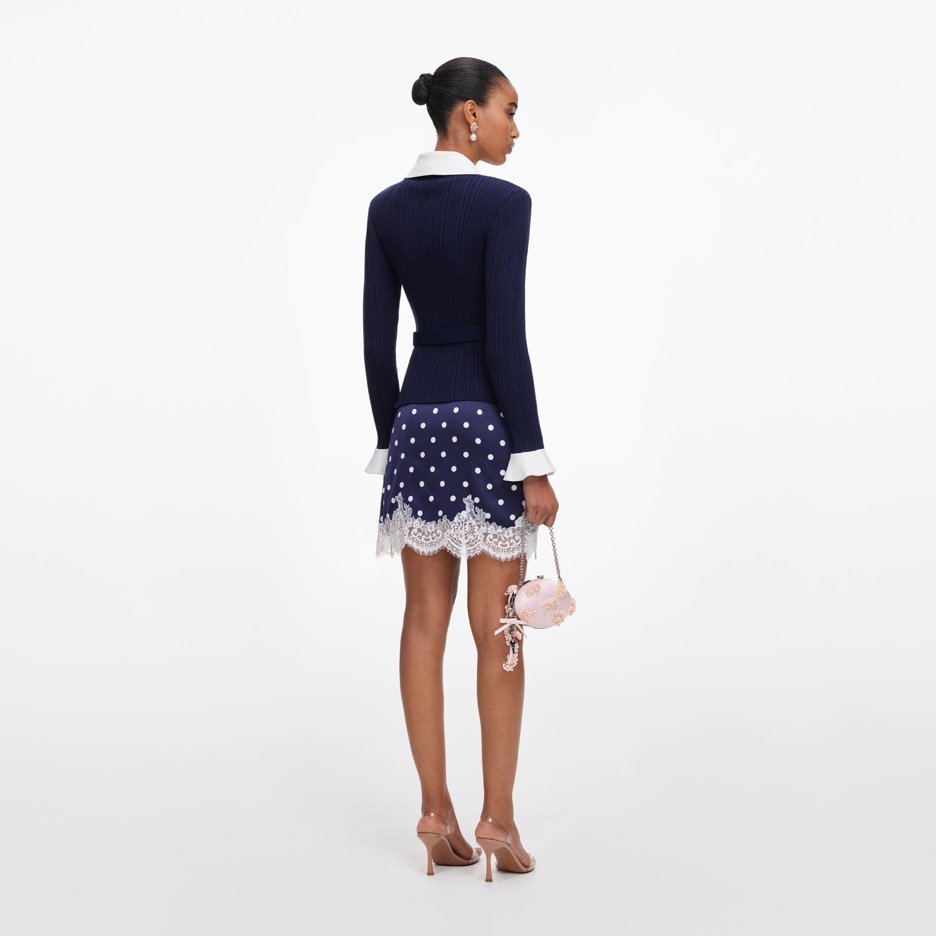 Back view of a woman wearing the Navy Ribbed Knit Cardigan