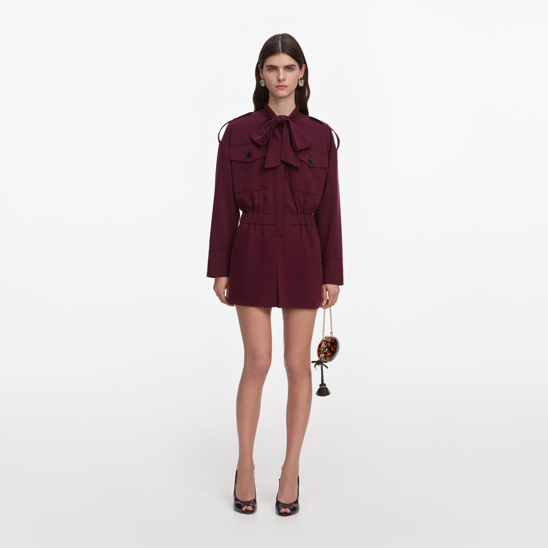 Front view of a woman wearing the Plum Twill Tie Neck Playsuit
