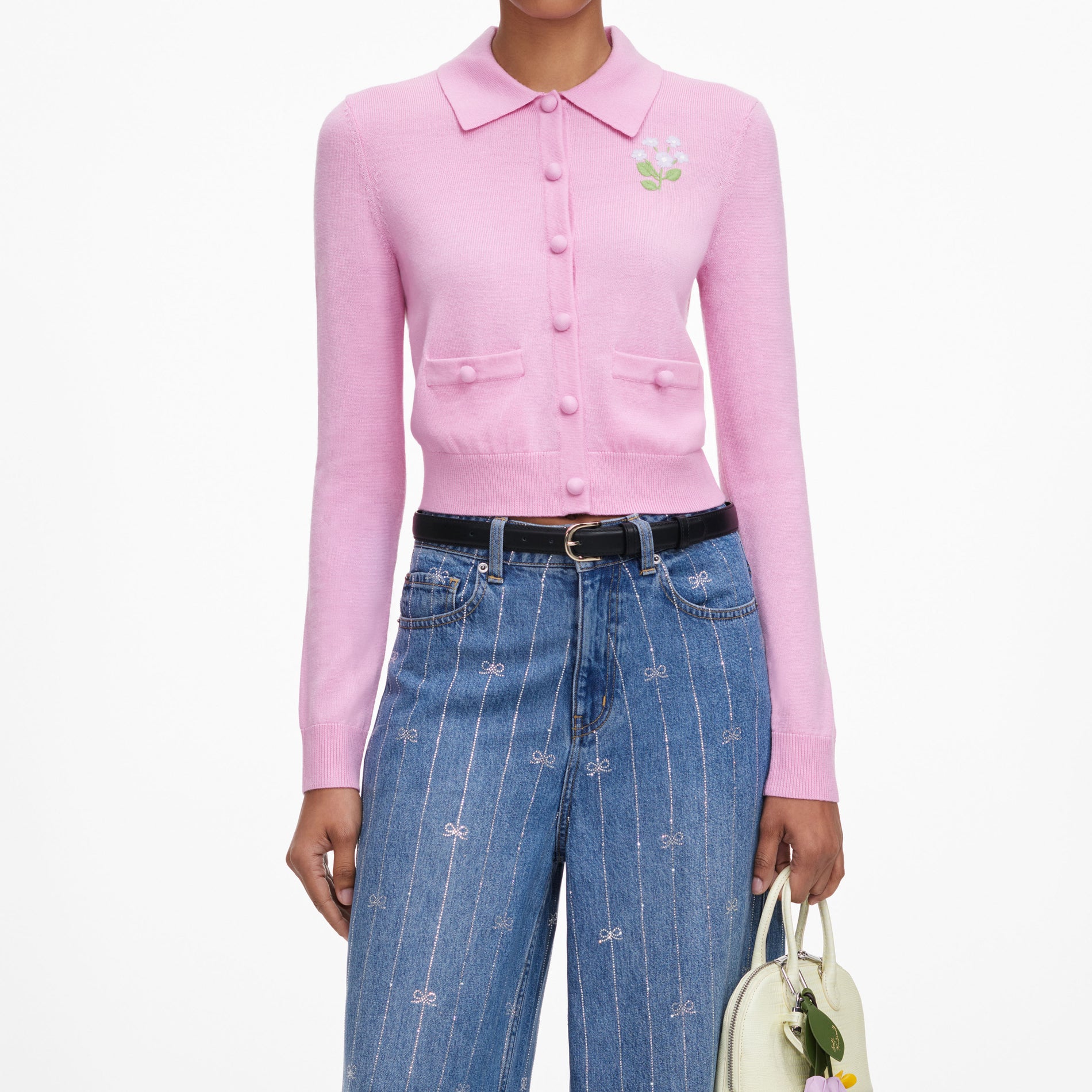 A close up of a woman wearing the Pink Flower Embroidered Knit Cardigan