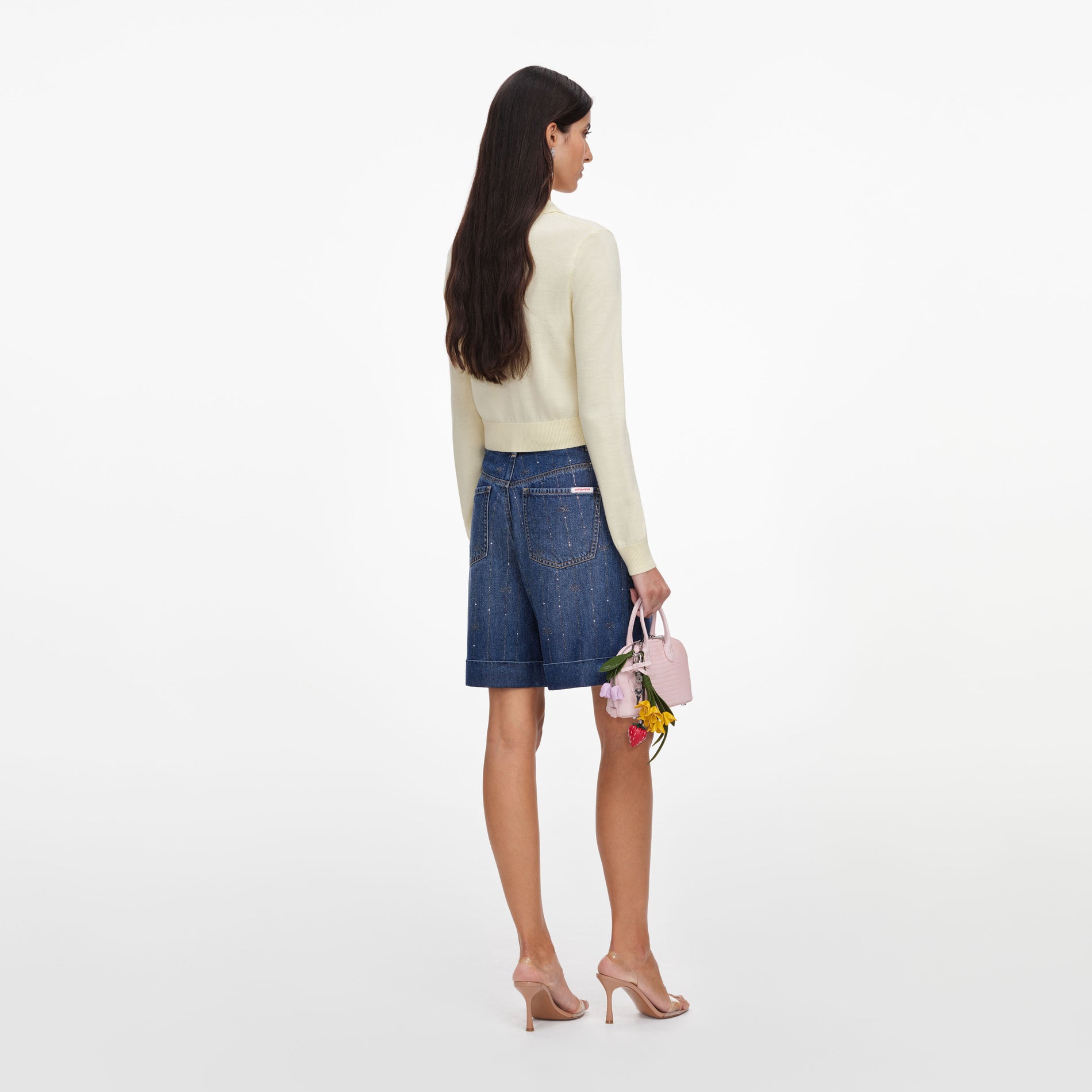 Back view of a woman wearing the Yellow Flower Embroidered Knit Cardigan