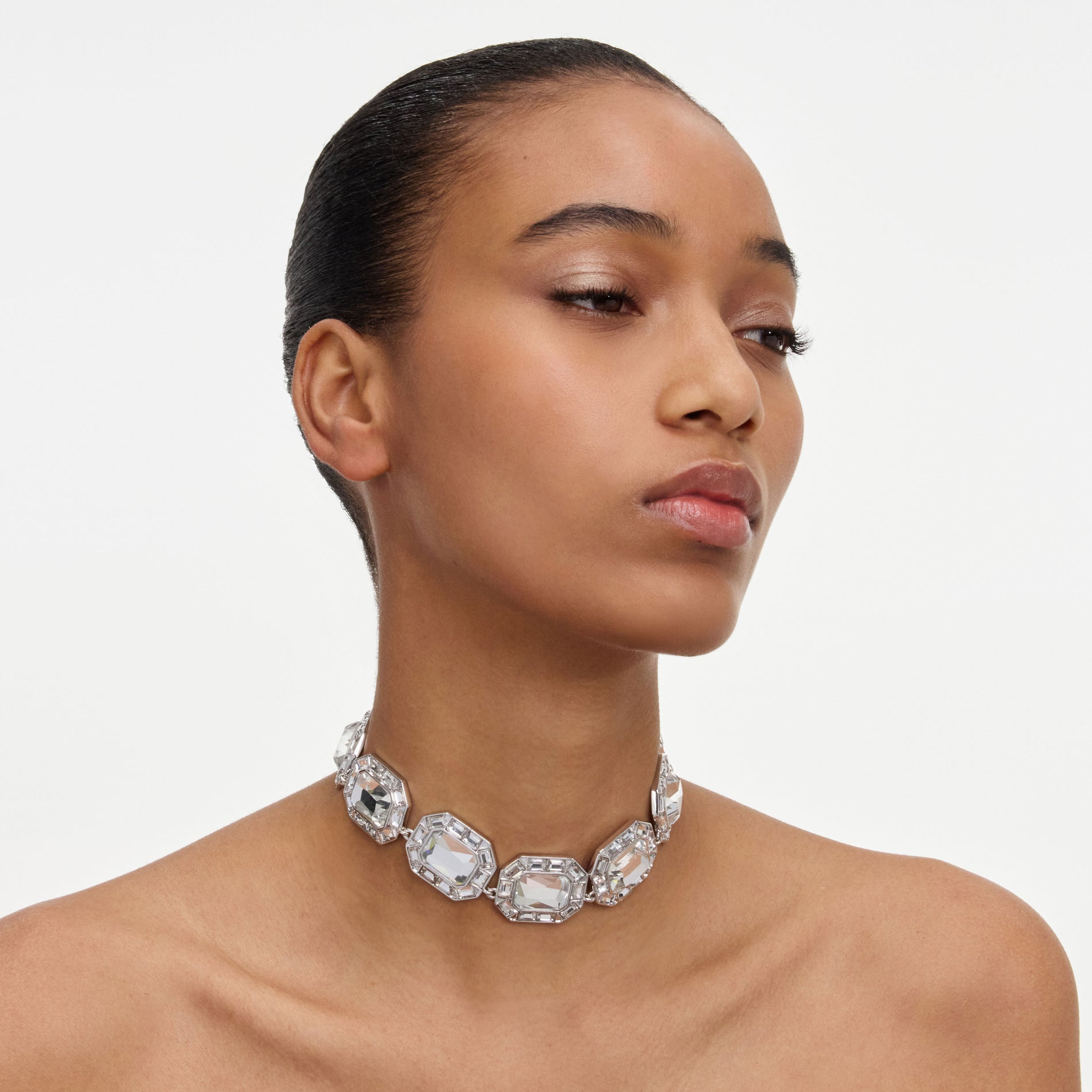 A close up of a woman wearing the Silver Crystal Necklace