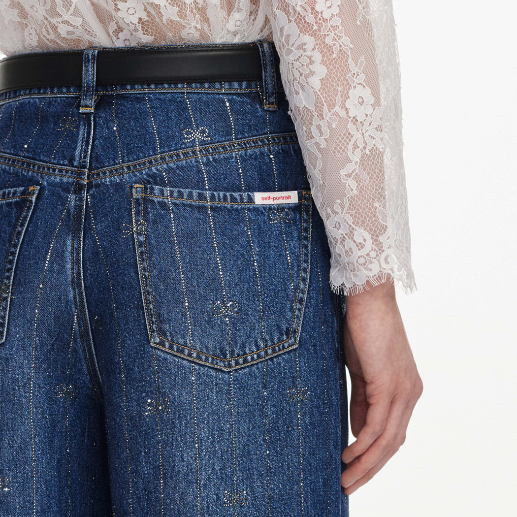 A close up of a woman wearing the Rhinestone Stripe Denim Jeans