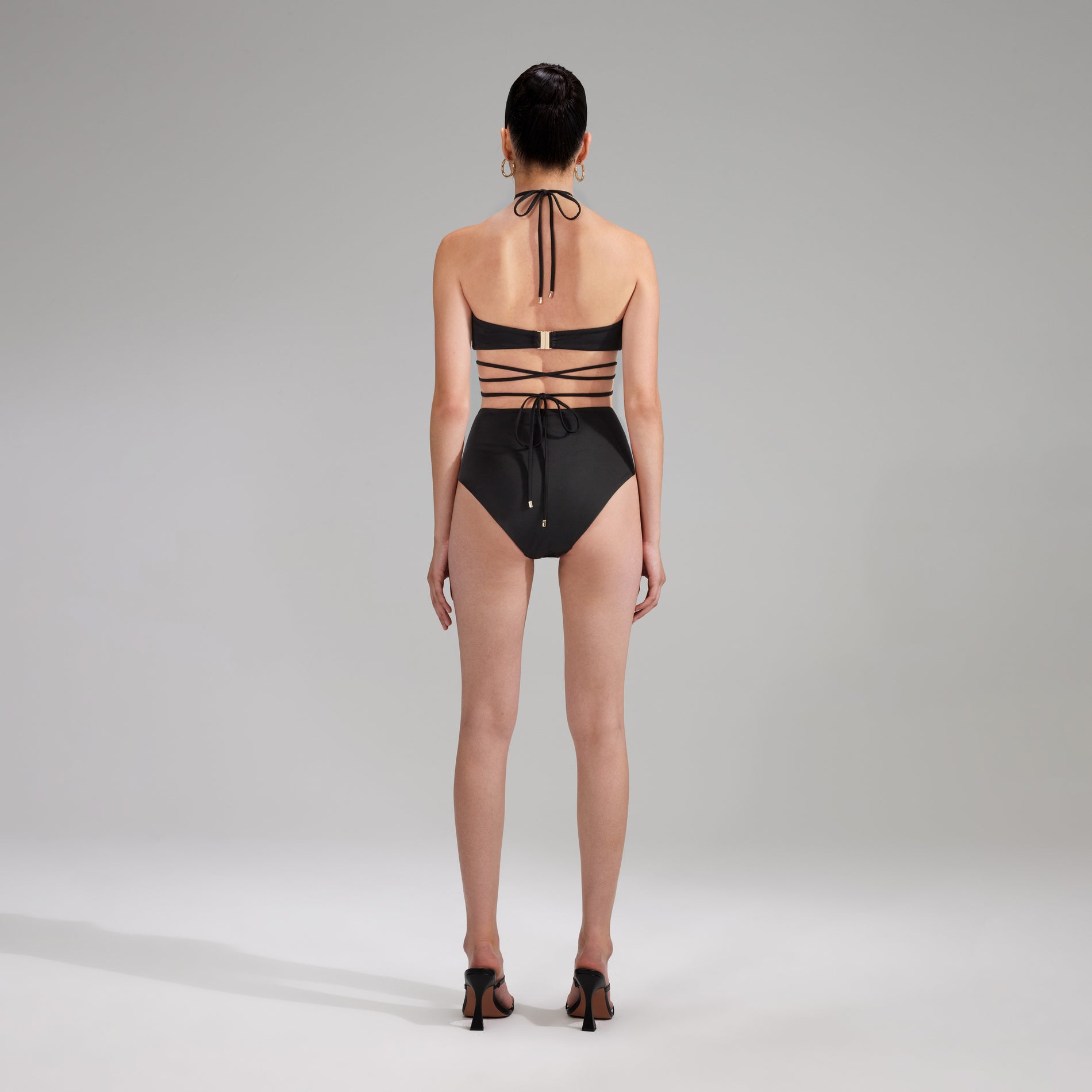 Back view of a woman wearing the Black High Cut Bikini Brief