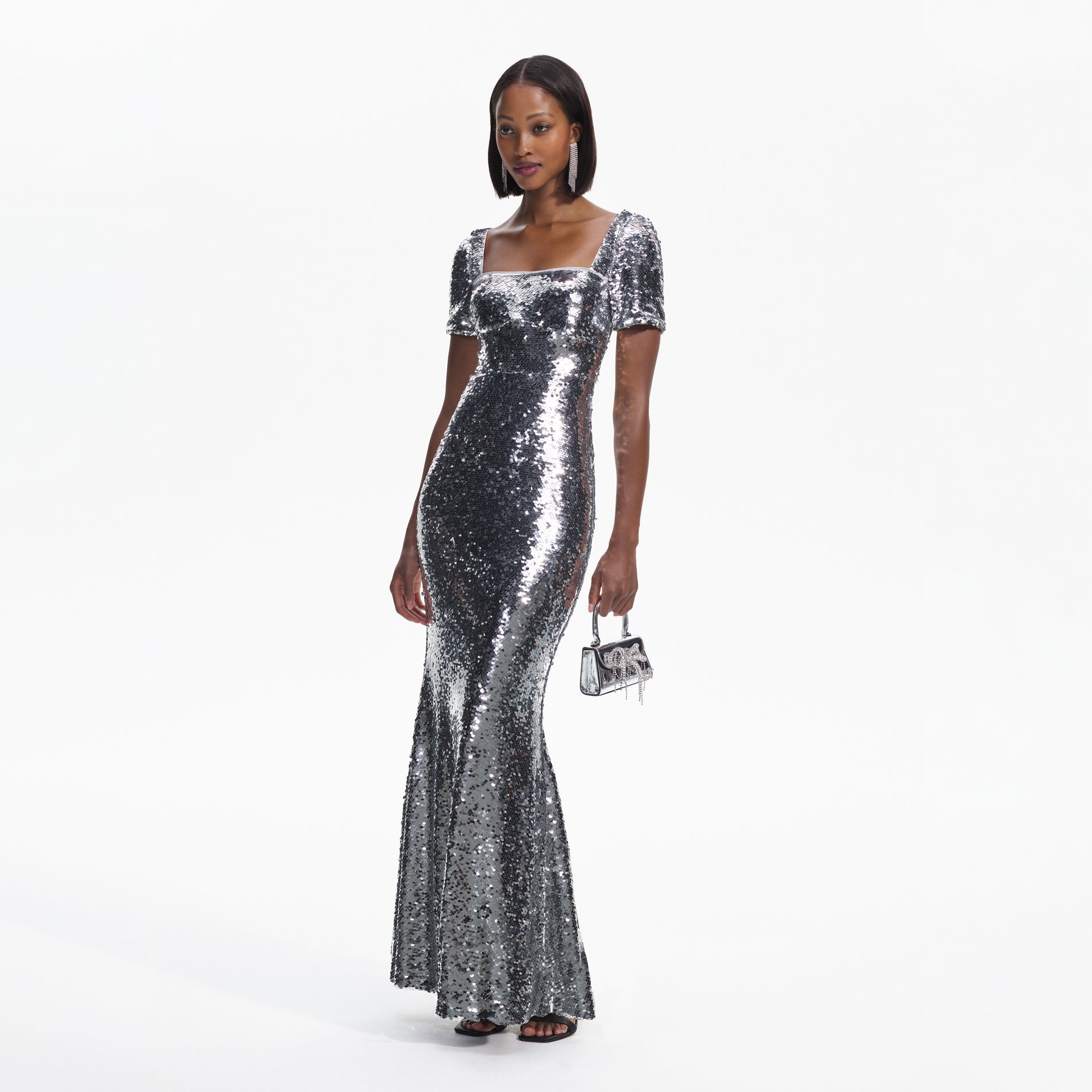Side view of a woman wearing the Silver Sequin Maxi Dress