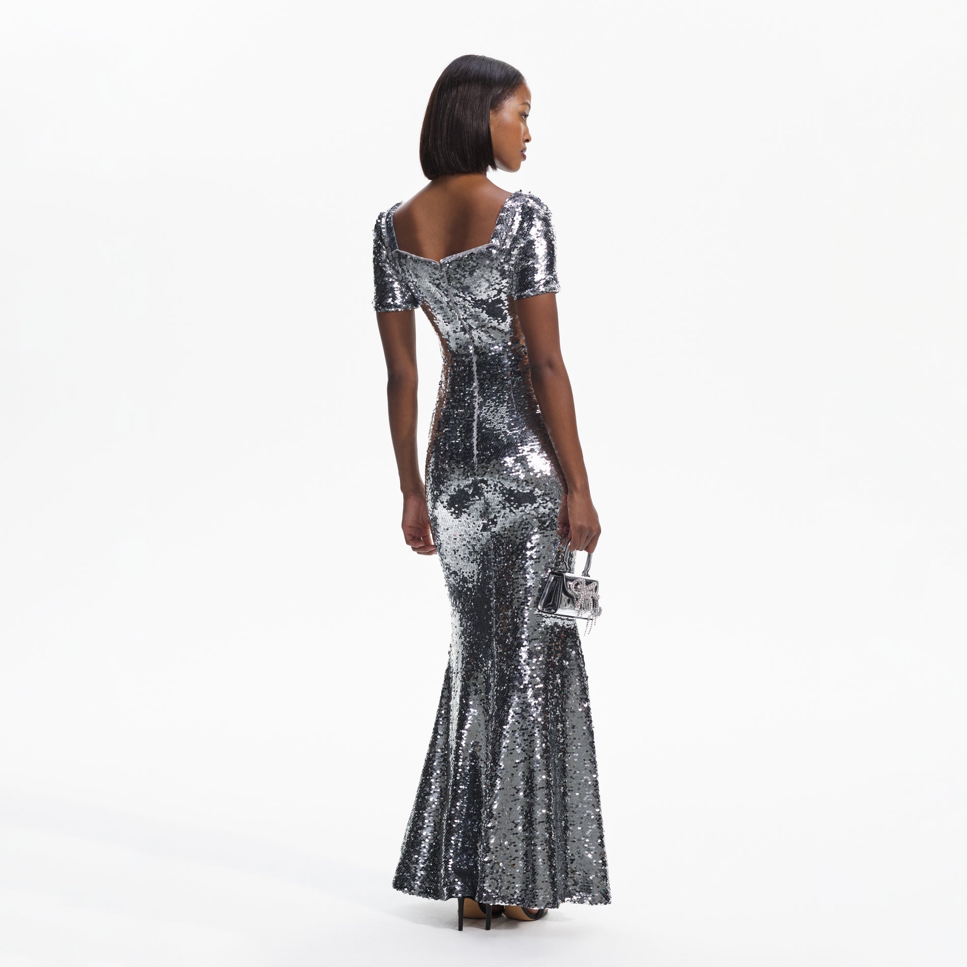Back view of a woman wearing the Silver Sequin Maxi Dress