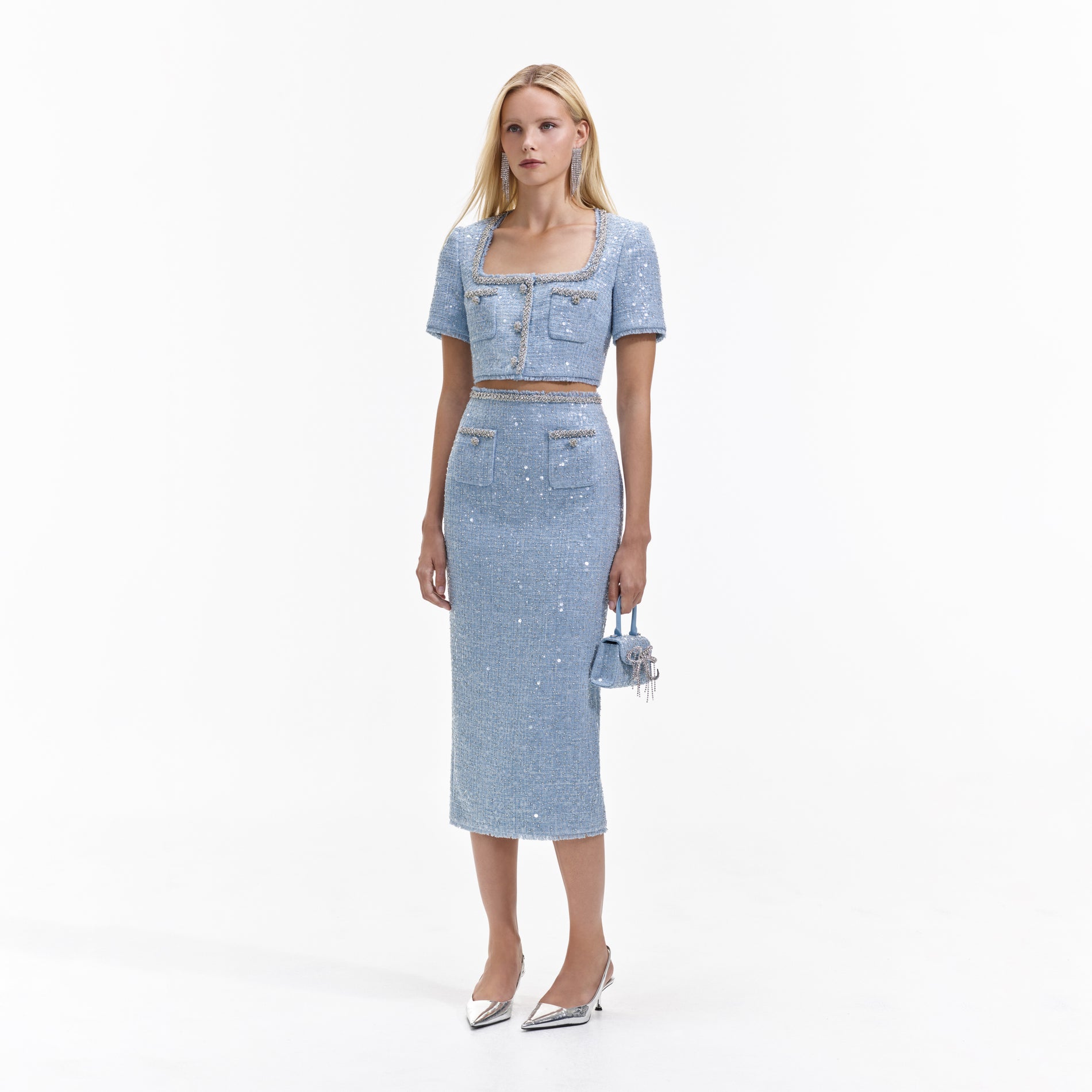 Side view of a woman wearing the Blue Sequin Boucle Midi Skirt