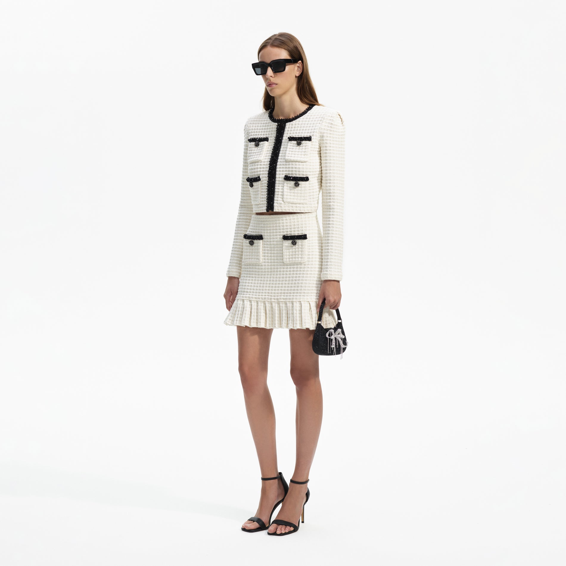 Side view of a woman wearing the Cream Textured Knit Mini Skirt