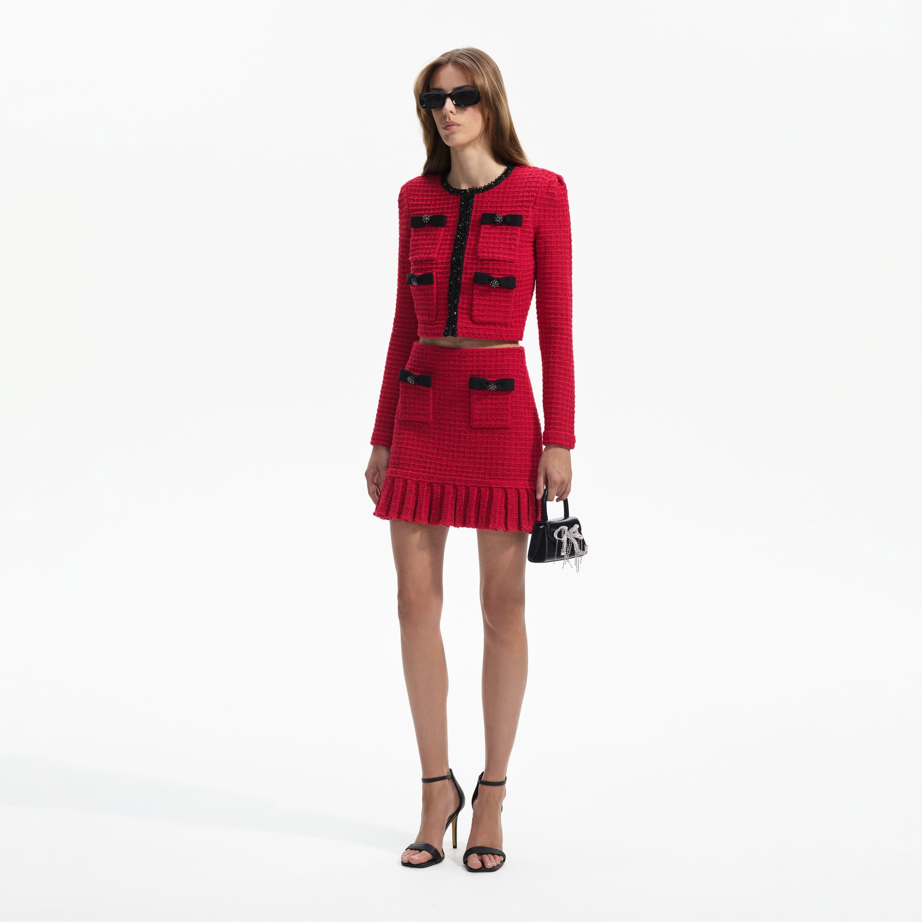 Side view of a woman wearing the Red Knit Cardigan
