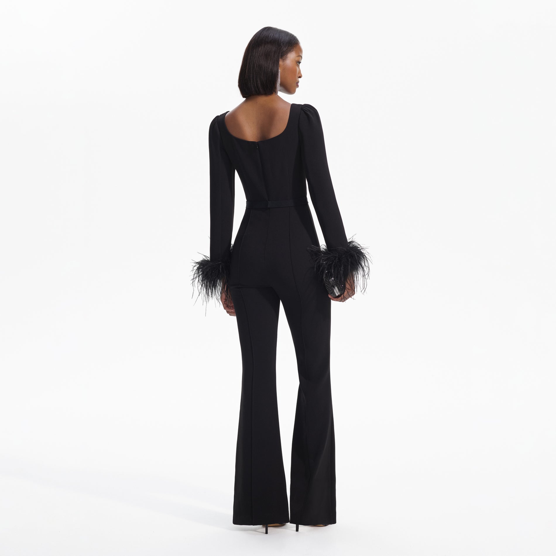 Back view of a woman wearing the Black Crepe Feather Jumpsuit