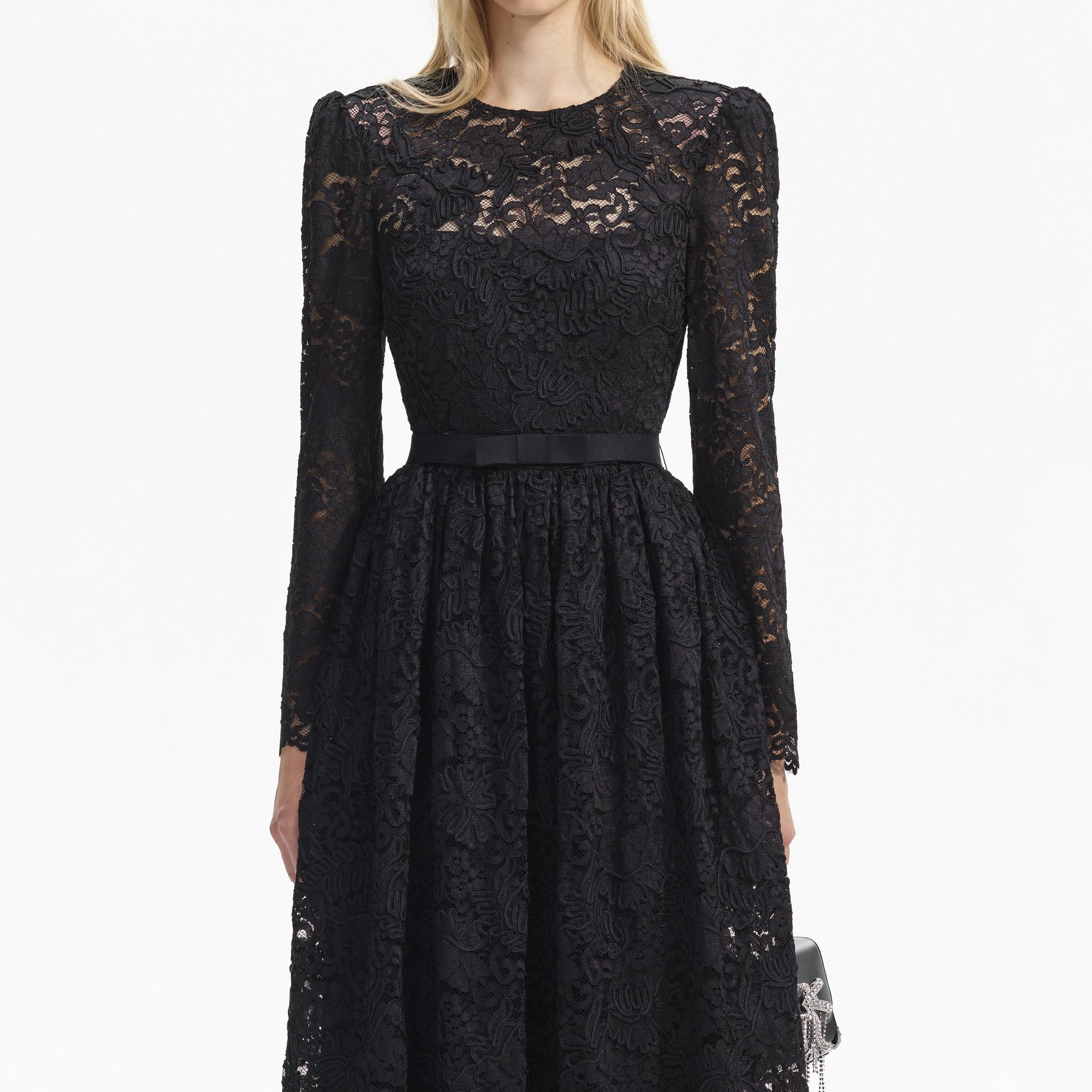 A close up of a woman wearing the Black Cord Lace Long Sleeve Midi Dress