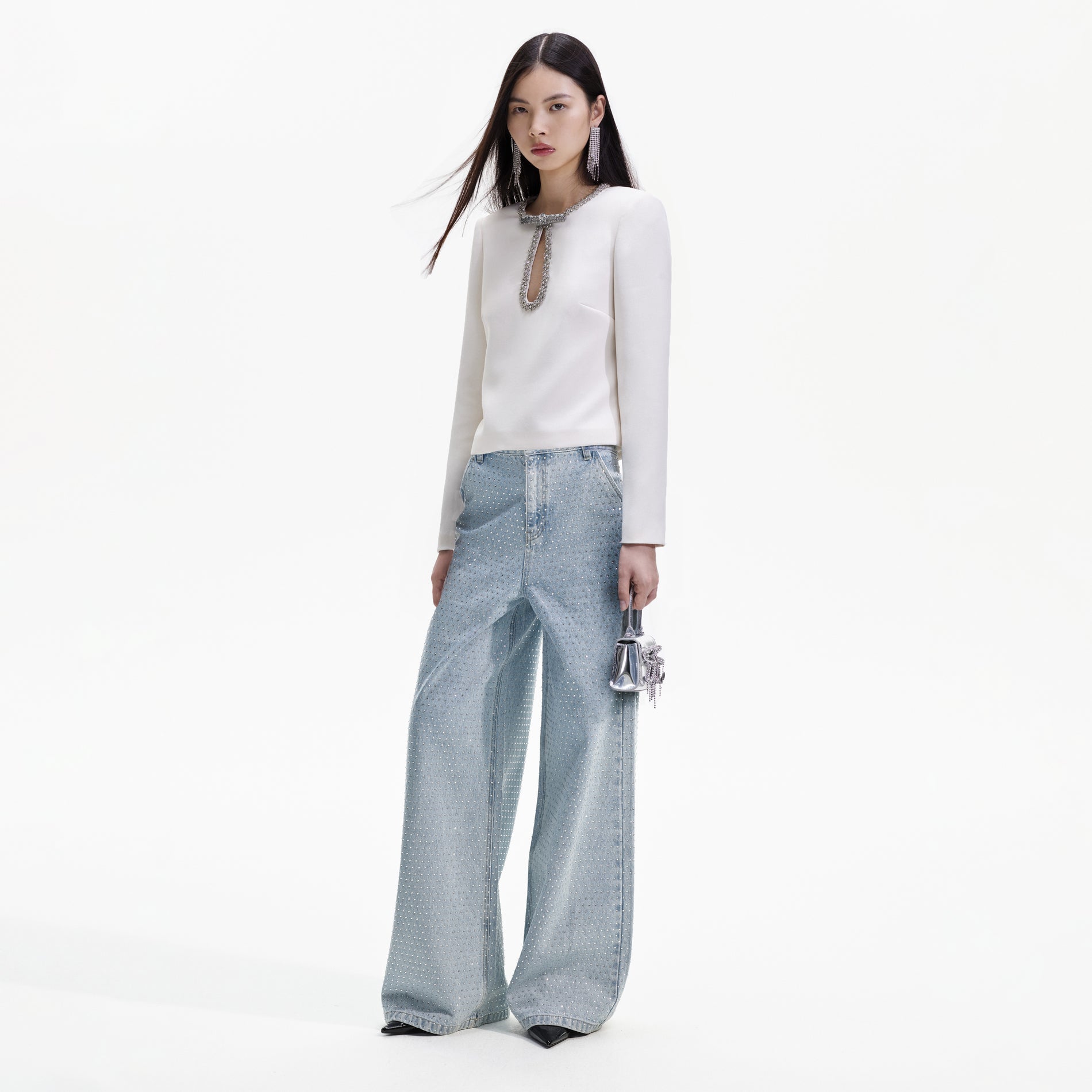 Side view of a woman wearing the Cream Crepe Diamante Top