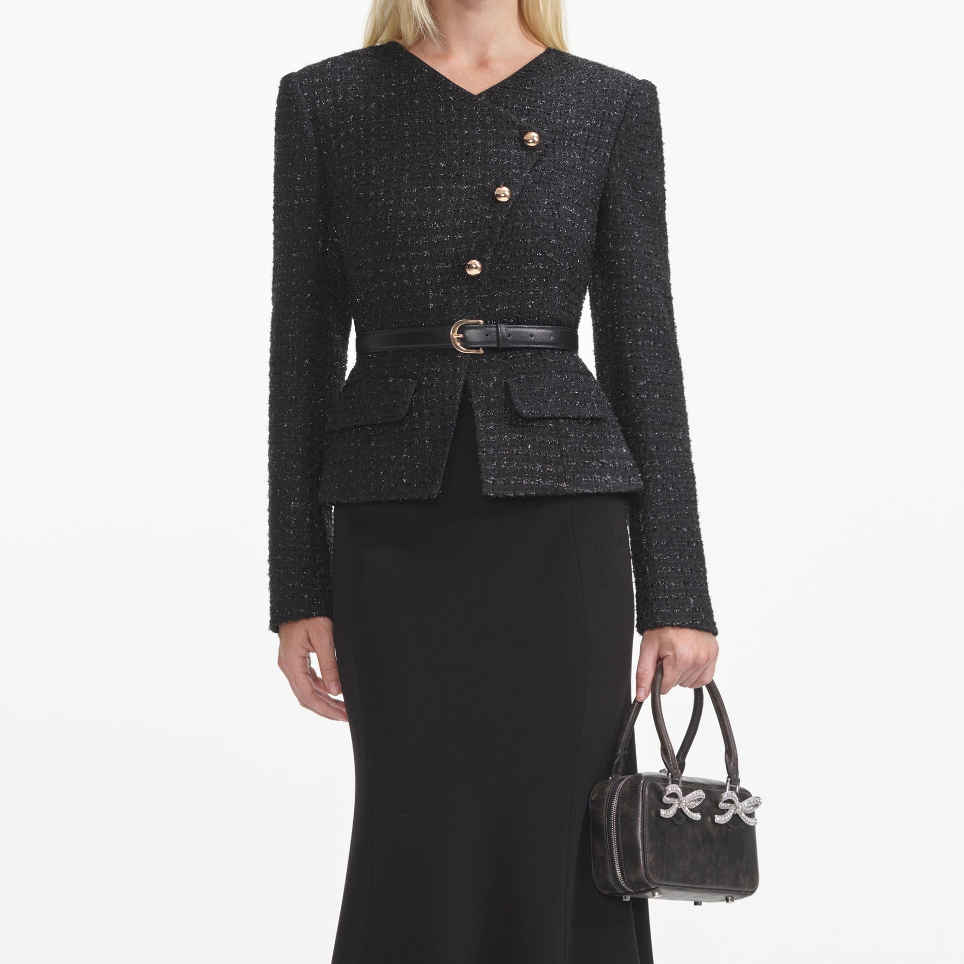 A close up of a woman wearing the Black Boucle Asymmetric Midi Dress