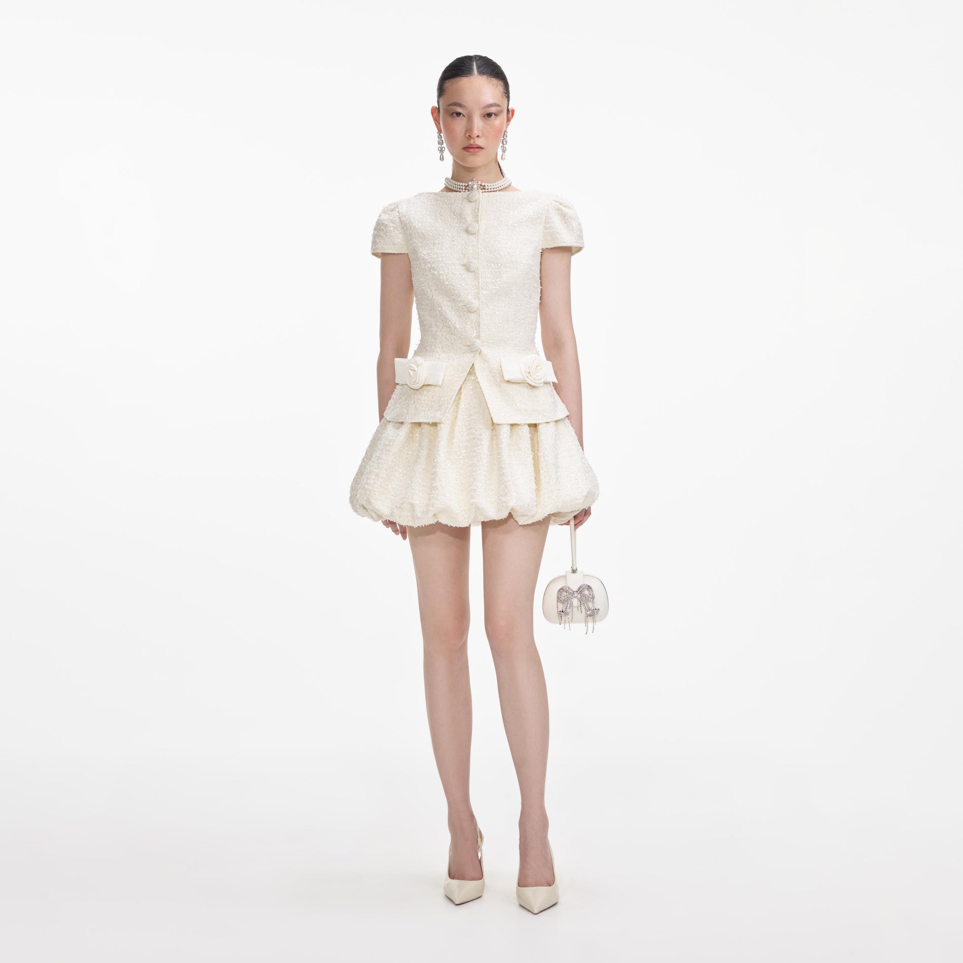 Front view of a woman wearing the Cream Boucle Bow Detail Mini Dress
