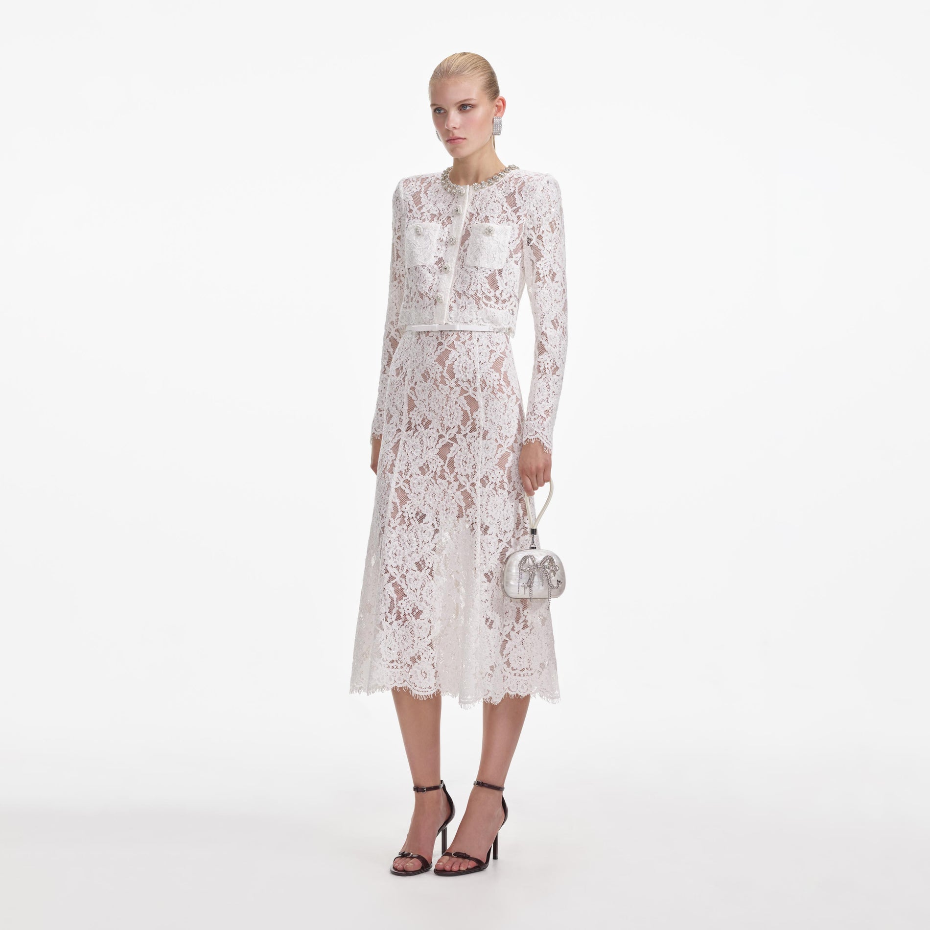 Side view of a woman wearing the White Lace Embellished Midi Dress