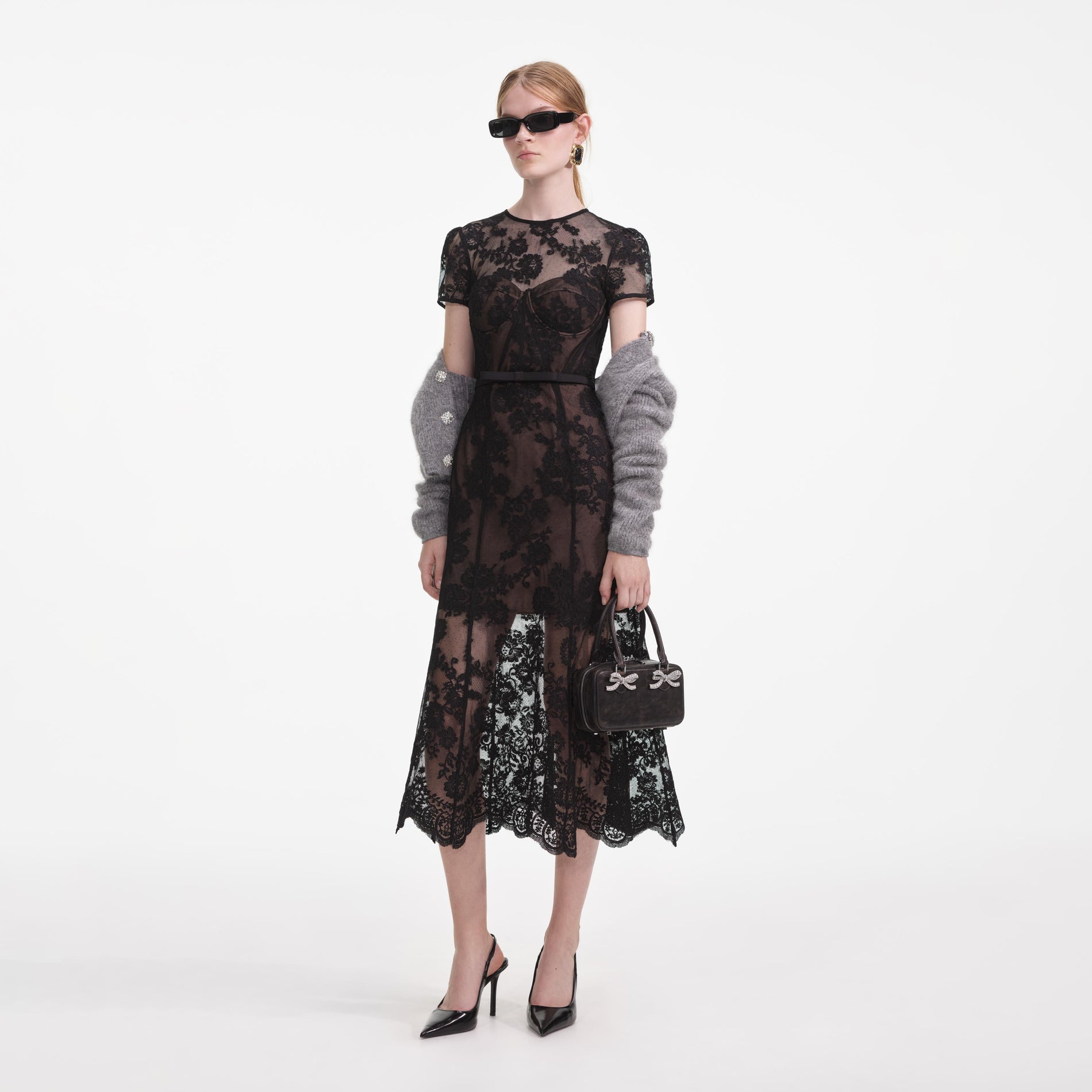 Side view of a woman wearing the Black Lace Bustier Midi Dress