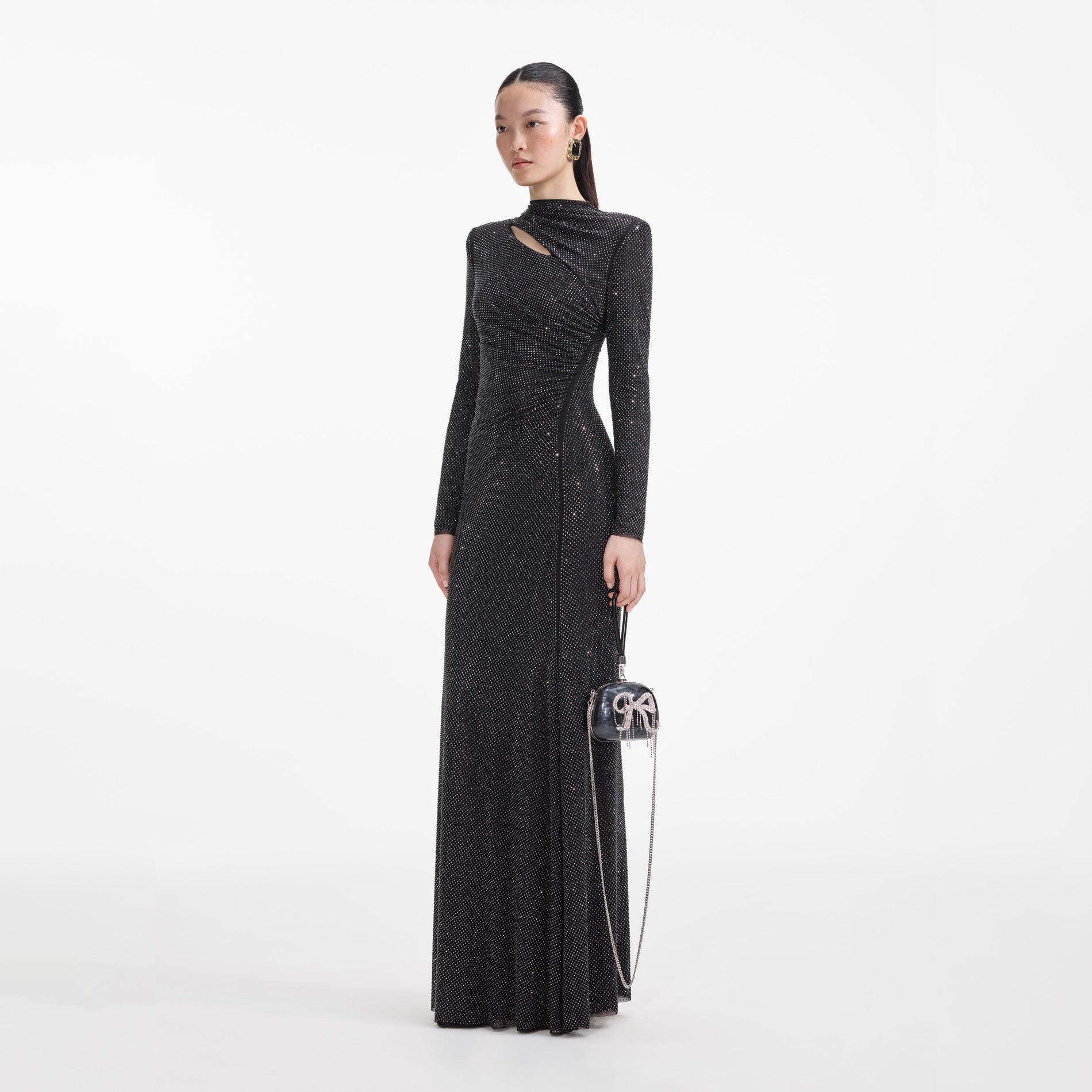 Side view of a woman wearing the Black Rhinestone Mesh Cut Out Maxi Dress