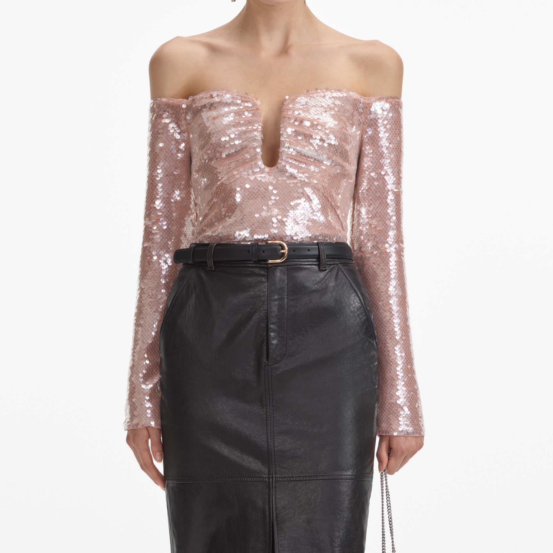 A close up of a woman wearing the Black Leather Midi Skirt