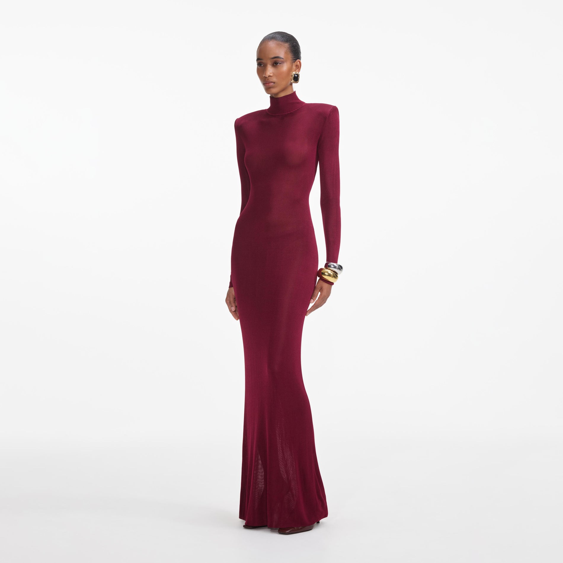 Side view of a woman wearing the Burgundy Viscose Knit Maxi Dress