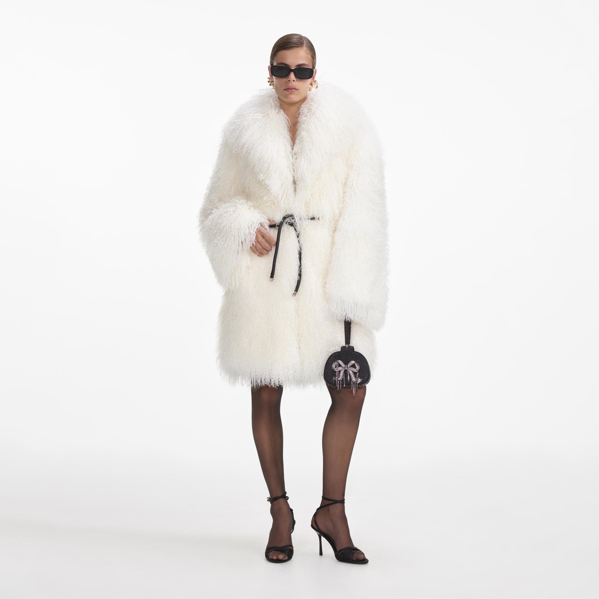 Front view of a woman wearing the Cream Shearling Coat