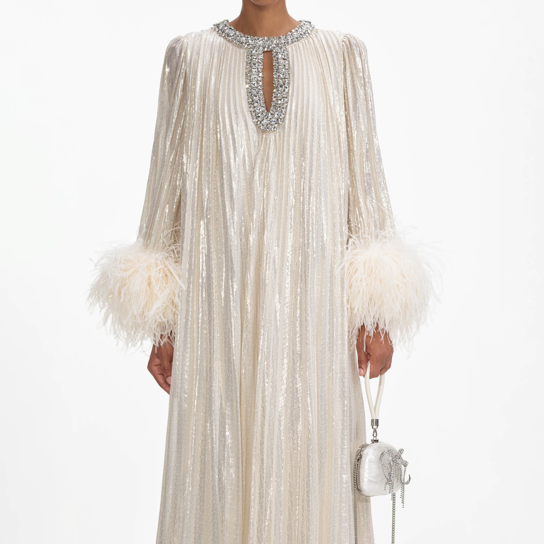 A close up of a woman wearing the Gold Metallic Feather Maxi Dress