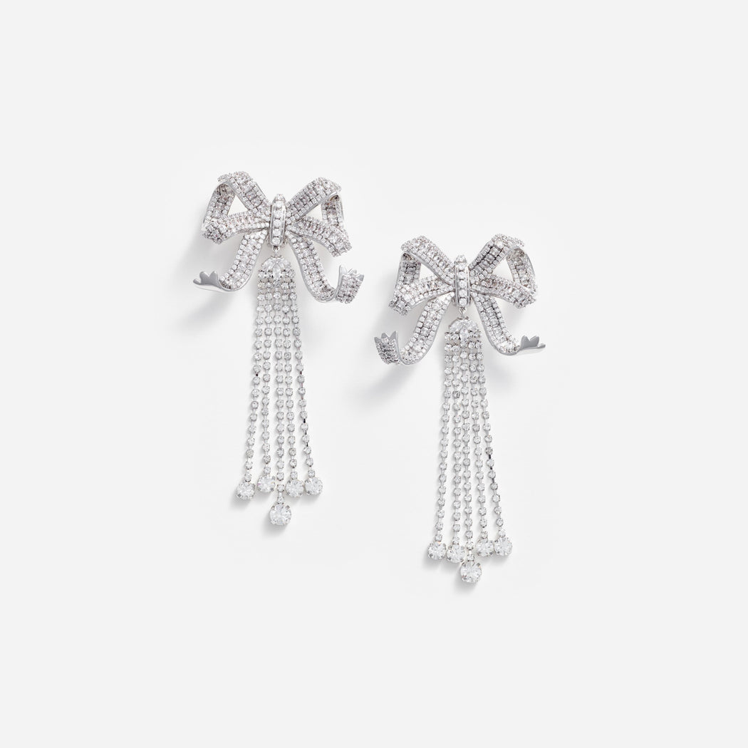 Front view of a woman wearing the Large Crystal Bow Droplet Earrings