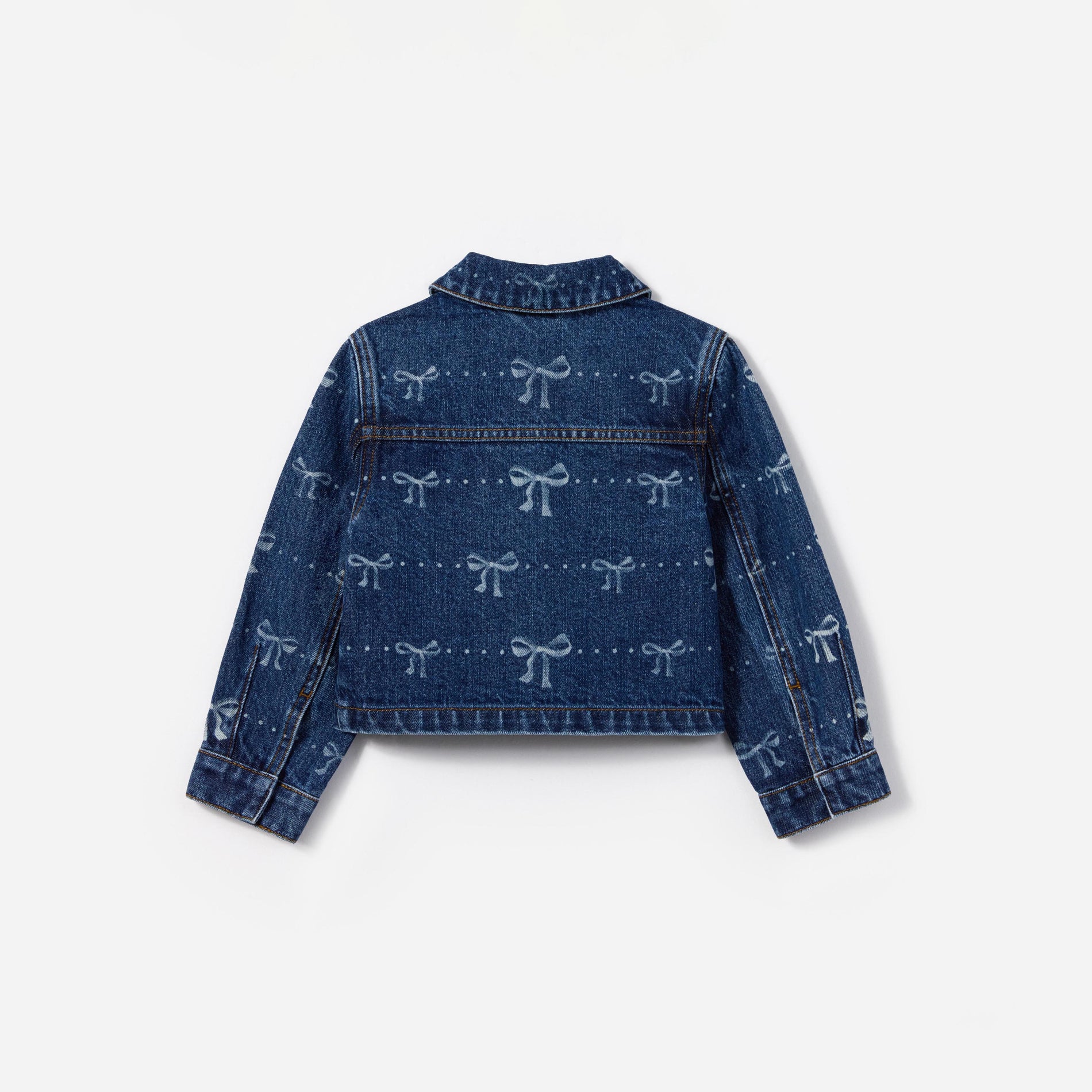 Side view of a woman wearing the Denim Bow Print Jacket