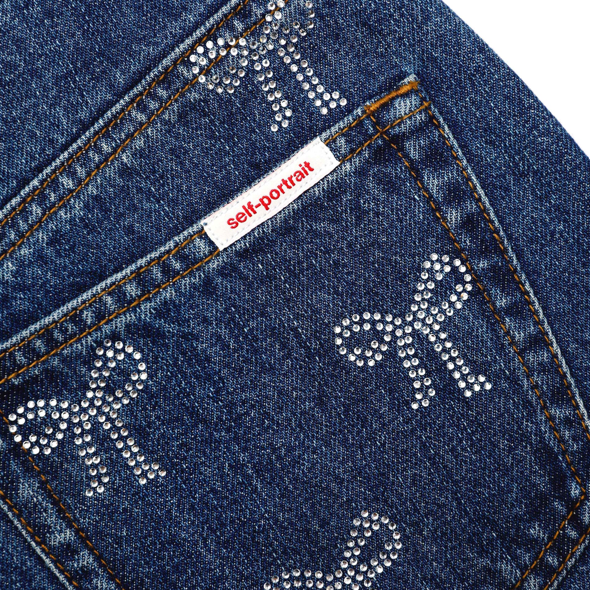 A close up of the fabric for the Rhinestone Bow Denim Jeans