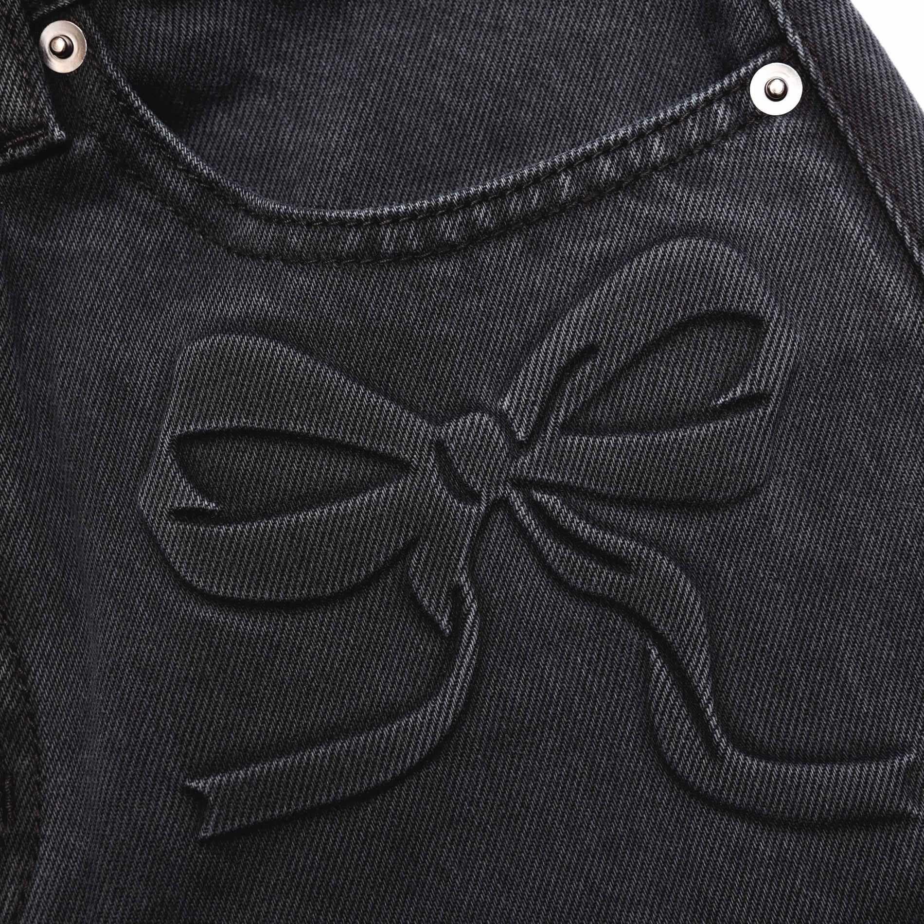 A close up of the fabric for the Grey Denim Bow Motif Jeans