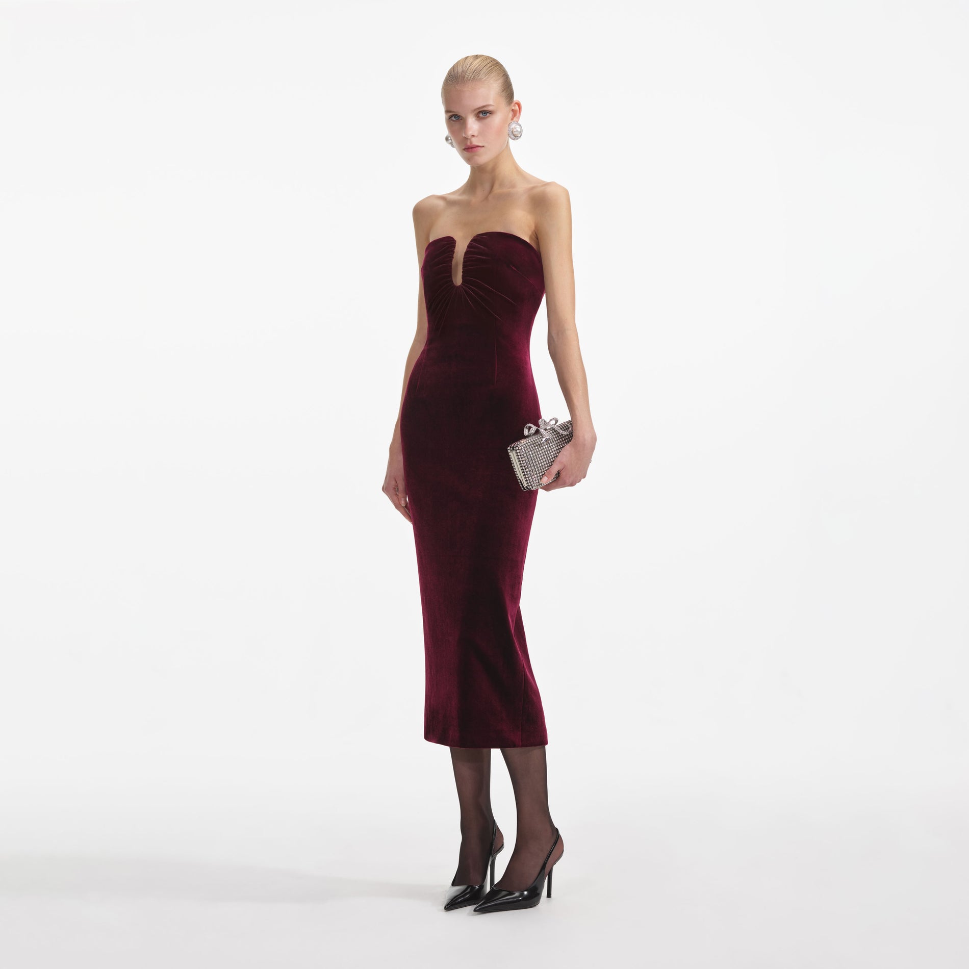 Side view of a woman wearing the Burgundy Velvet Midi Dress