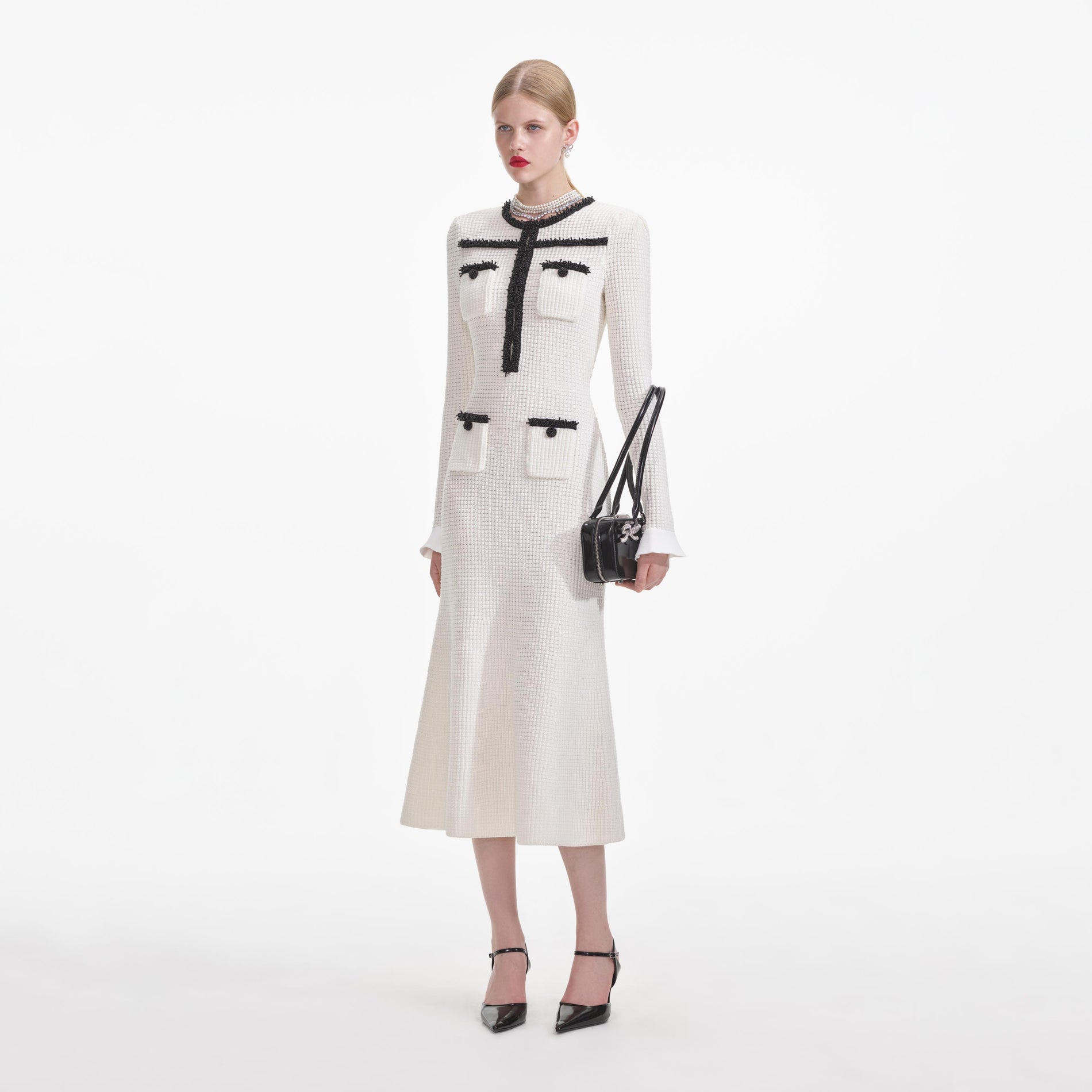 Side view of a woman wearing the White Knit Contrast Trim Midi Dress