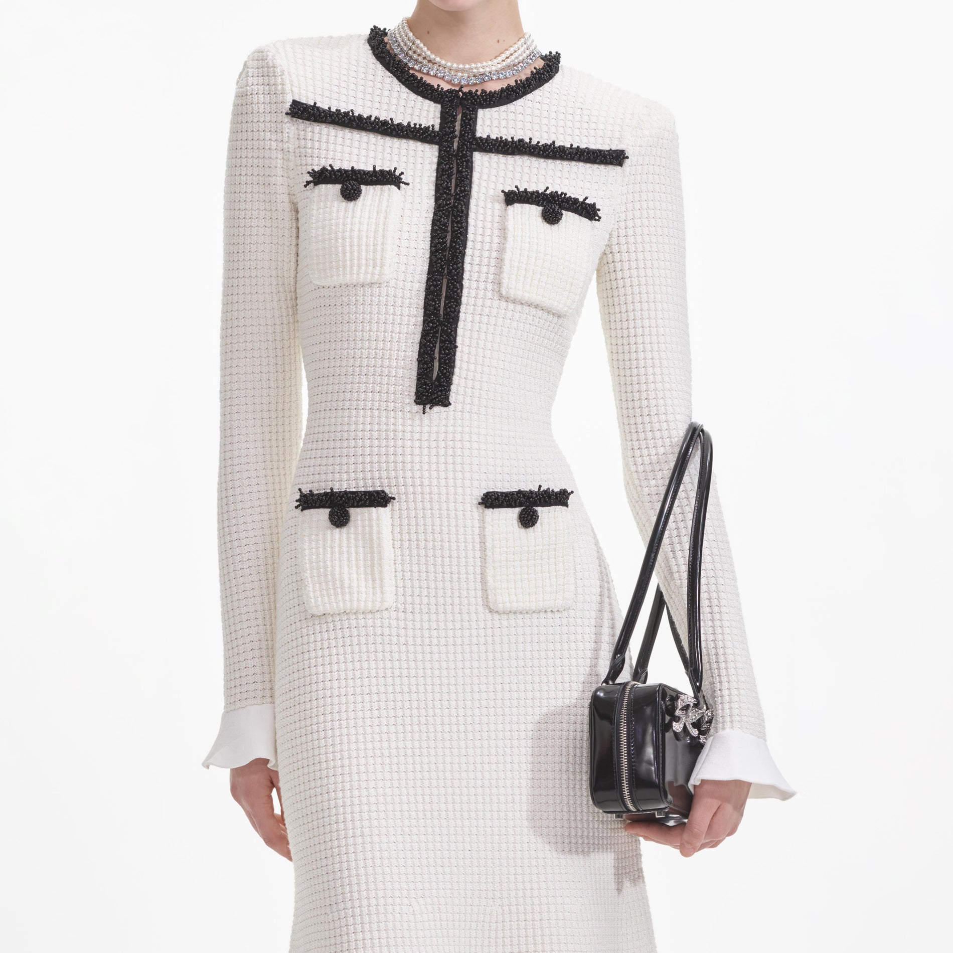 A close up of a woman wearing the White Knit Contrast Trim Midi Dress